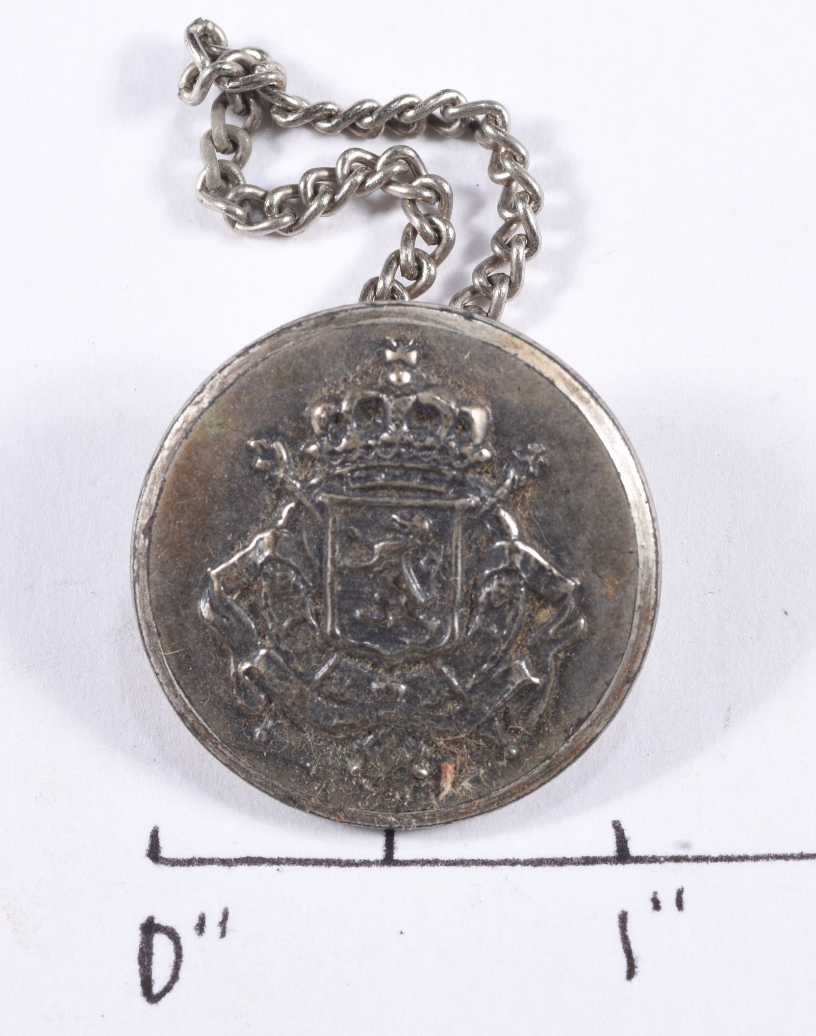 Vintage Heraldic Coat of Arms Chain Button: Large silver-tone metal chain button or cloak fastener featuring a raised crowned heraldic coat of arms to the face and attached metal chain to reverse. Approximately 1 inch diameter excluding chain. 