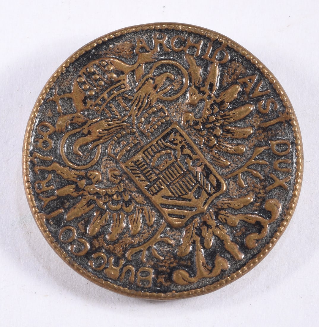 Large Ornate Heraldic Brass Button: Large round brass-tone button with an elaborate heraldic design incorporating multiple eagles, crown, shield and scrolling decoration with raised lettering around the perimeter. Metal shank to reverse