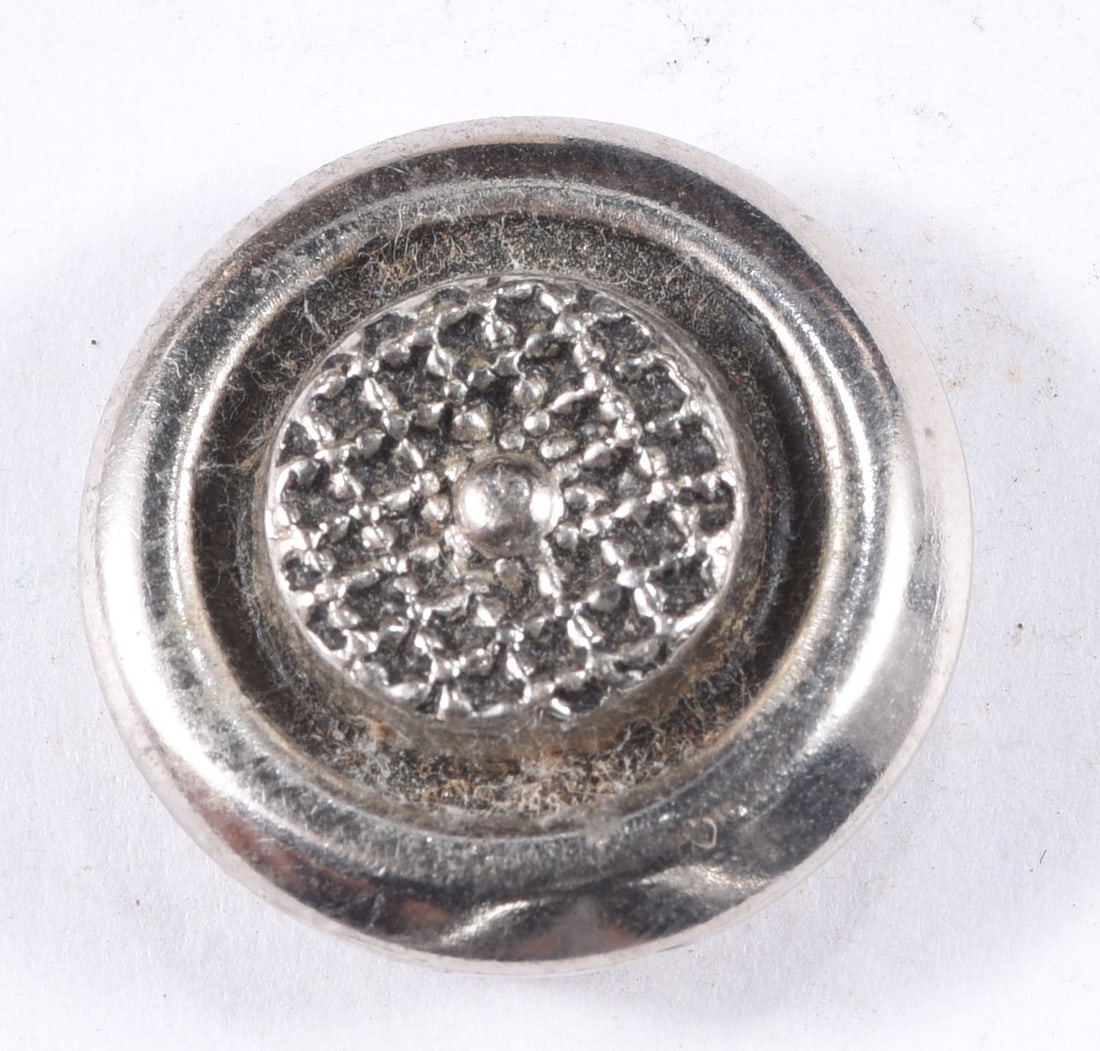 Antique Silver-Tone Ornate Floral Button: Antique silver-tone metal shank button with a highly detailed raised floral or rosette center surrounded by concentric molded borders. Metal shank to reverse. Approximately 3/4 inch diameter. Oxidatio