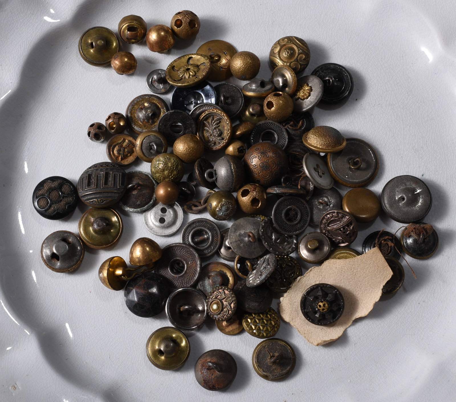 Collection of Antique & Vintage Metal Buttons: Large collection of antique and vintage metal garment buttons in brass, copper, silver-tone and darkened finishes. Includes domed, embossed, floral, geometric, pierced and shank examples in numerous s