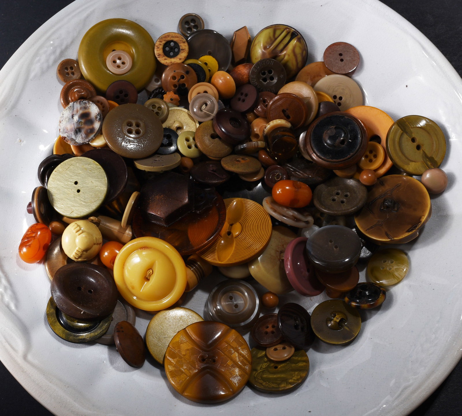 Large Collection of Vintage Brown, Amber & Tan Buttons: Large collection of vintage garment buttons in brown, amber, tan, cream and black. Includes two-hole, four-hole and shank examples in assorted sizes with domed, ringed, molded and geometric designs. N