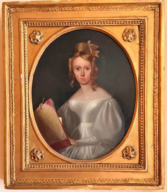 Fine Irish Regency Oil Portrait of Lady Artist Jane Austen Elegance c.1820 1830: Portrait of Margaret Cross, (portrait of a lady artist, seated in Regency style, holding an artists sketchbook). Irish School, early 19th century (circa 1820–1835) Oil on panel, oval, in a gilt fram