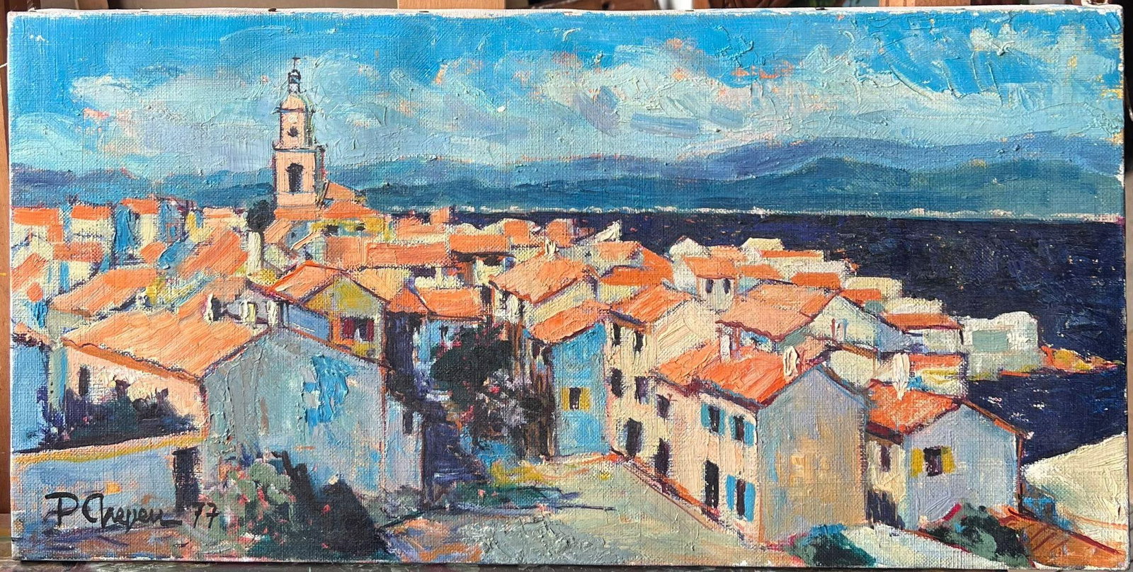 Pierre Neveu St Tropez Skyline Rooftops 1977 Oil Painting: St. Tropez, South of France by Pierre Neveu (French, b.1929), signed lower left and dated 1977. Oil on canvas, unframed. Canvas: 12 x 24 inches. Provenance: from the artist’s studio sale in France. 