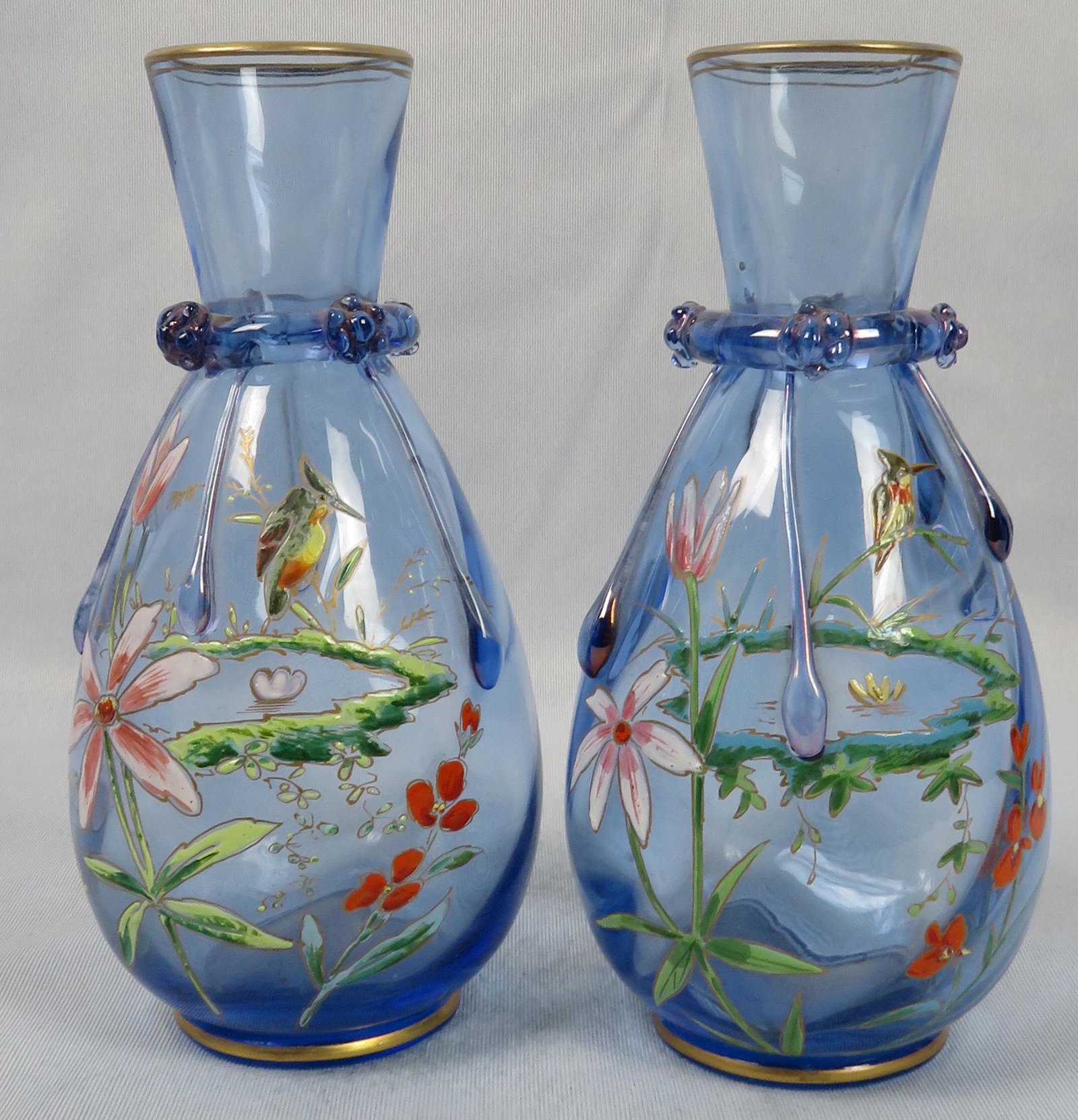 Pair Victorian Era Moser Enameled Bohemian Glass Vases: Maker: Moser Location of Manufacture: Bohemia (Czech Republic) Period of Manufacture: Late 18th to Early 19th Century Materials: Enameled Art Glass Dimensions (each): 7"(h) ; 3 1/8" maximum diameter W