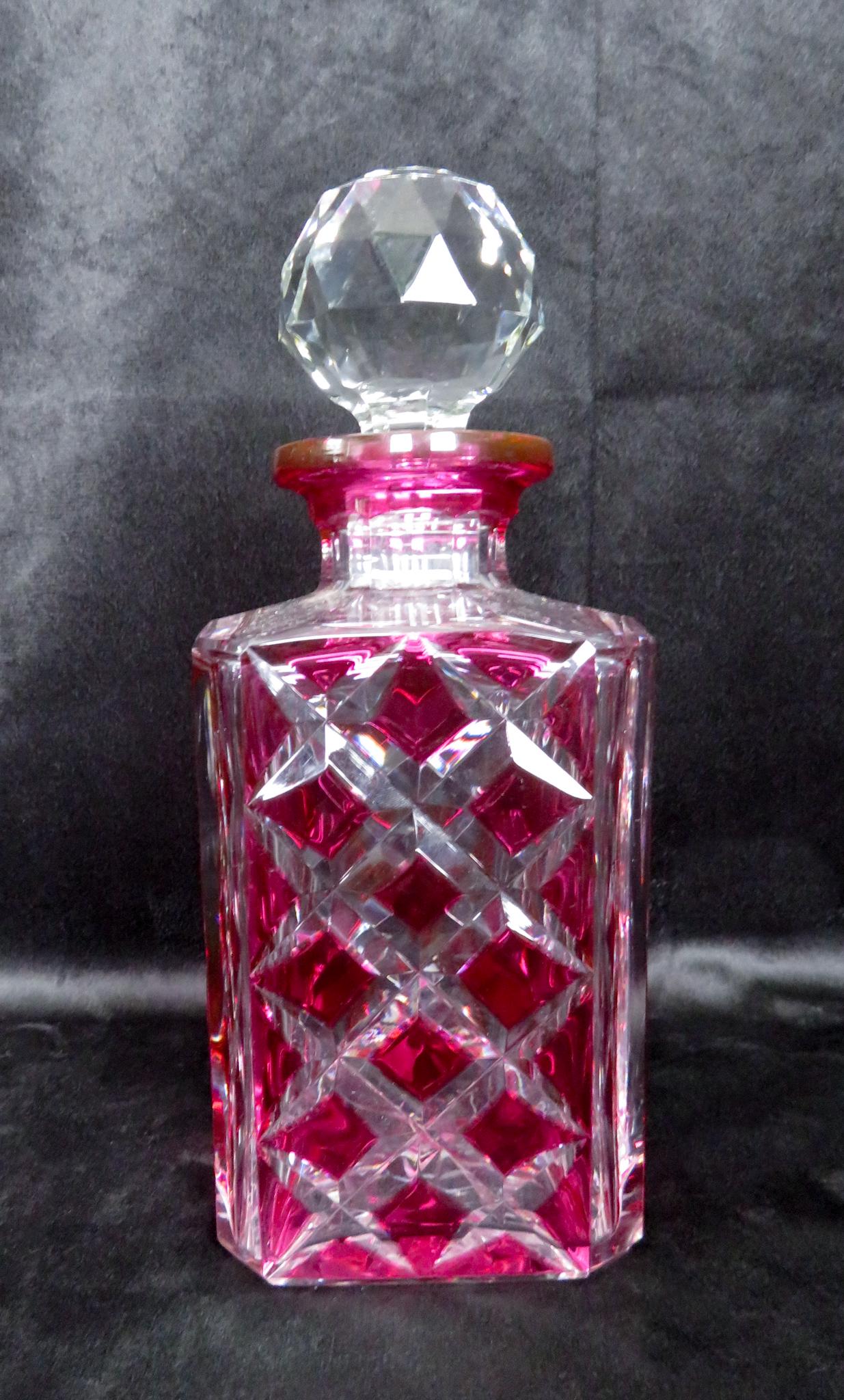 Val St. Lambert Ruby Overlay Cut to Clear Decanter: Manufacturer: Val St. Lambert Crystal Period of Manufacture: mid-20th Century Location of Manufacture: Seraing, Belgium Dimensions: 9 1/2"(h) ; 3 3/4"square Weight: 4 lbs. 11 oz. For your consideratio