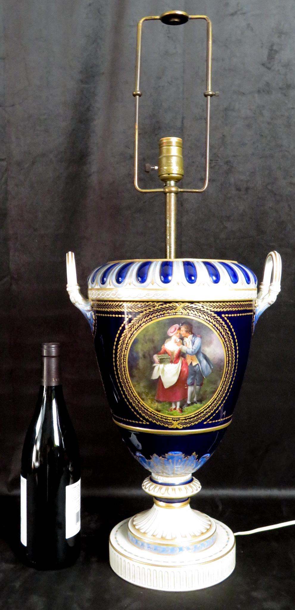 Berlin KPM Gilt Cobalt Porcelain Handled Urn Lamp: Manufacturer: Königliche Porzellan-Manufaktur Berlin (KPM) Period of Manufacture: 19th Century Location of Manufacture: Berlin, Germany Porcelain Body Dimensions: 16"(h) ; 11 1/2" handle to handle He