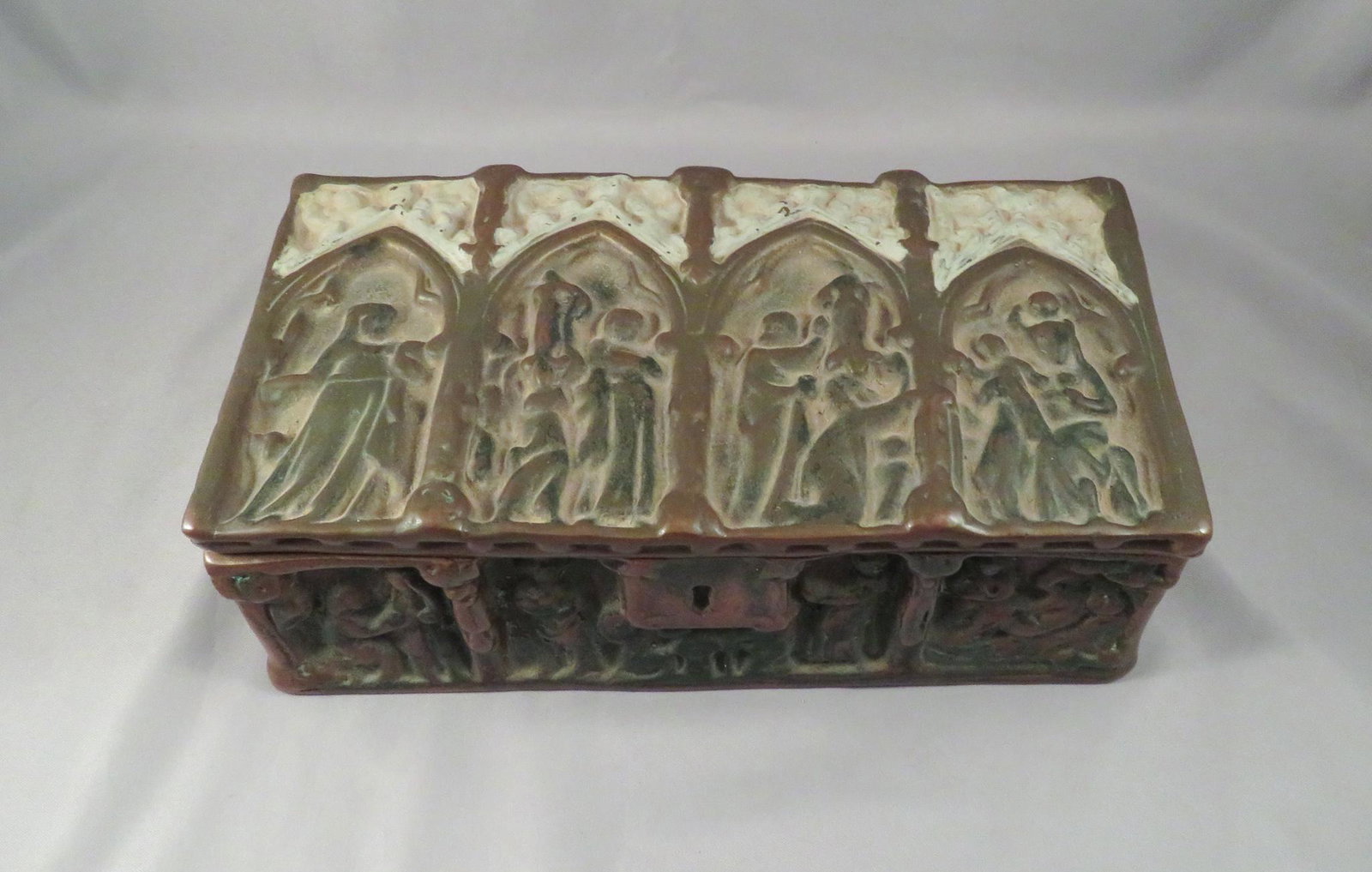 Gothic Revival Ecclesiastical Bronze Jewelry Box Casket: Dimensions: 8 1/2"(l) x 4"(w) x 2 3/4"(h) Weight: 3 lbs. 7 oz. For your consideration is a beautifully rendered bronze box in the Gothic style. The box is adorned on all sides with an ecclesiastical s