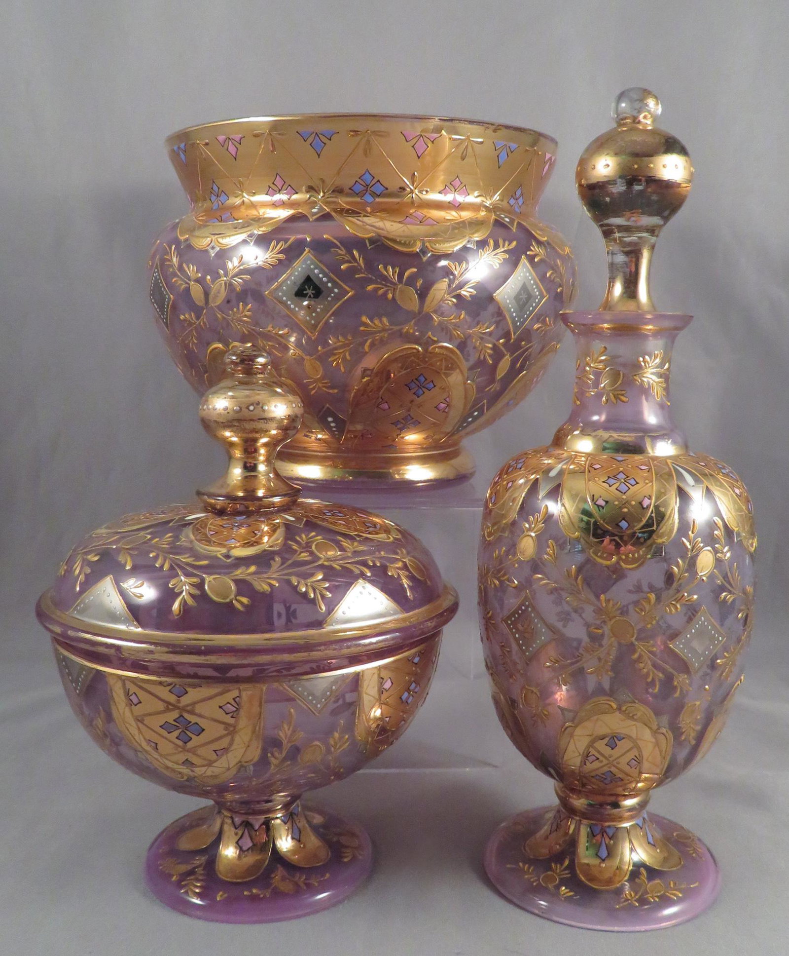 Victorian Bohemian Moser Enameled Glass Vanity Set: Manufacturer: attributed to Moser Location of Manufacture: Bohemian/Czech Period of Manufacture: late 19th Century Dimensions of Bottle: 6 3/4"(h) Dimensions of Lidded Jar: 4 3/4"(h) ; 3 3/8" maximum 