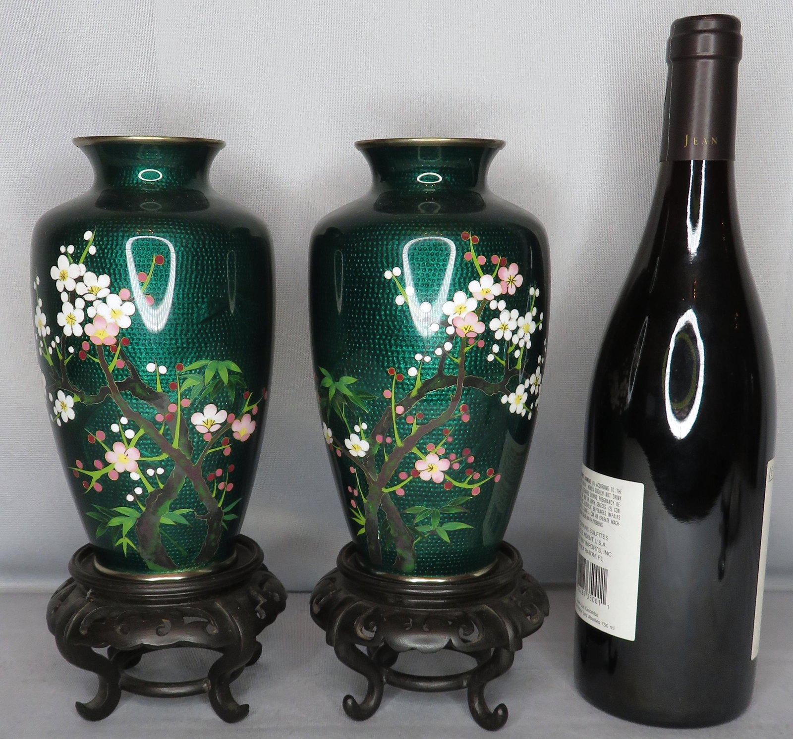 Mirror Pair of Japanese Green Cloisonne Vases & Stands: Location of Manufacture: Japan Dimensions of Vases (each): 7 1/4"(h) ; 4" across shoulder Weight of Vases (both): 2 lbs. 9 oz. Height of Stands (each): 2 3/4"(h) For your consideration is a stunning m