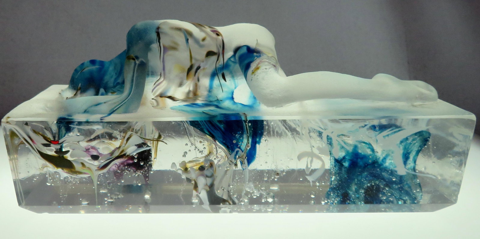 1989 Wendy Taylor Reclining Nude Art Glass Sculpture: For your consideration is a studio glass sculpture by artist Wendy Taylor. The sculpture was created in 1989 and depicts a nude figure becoming one with the ground beneath. The upper surface (above gr