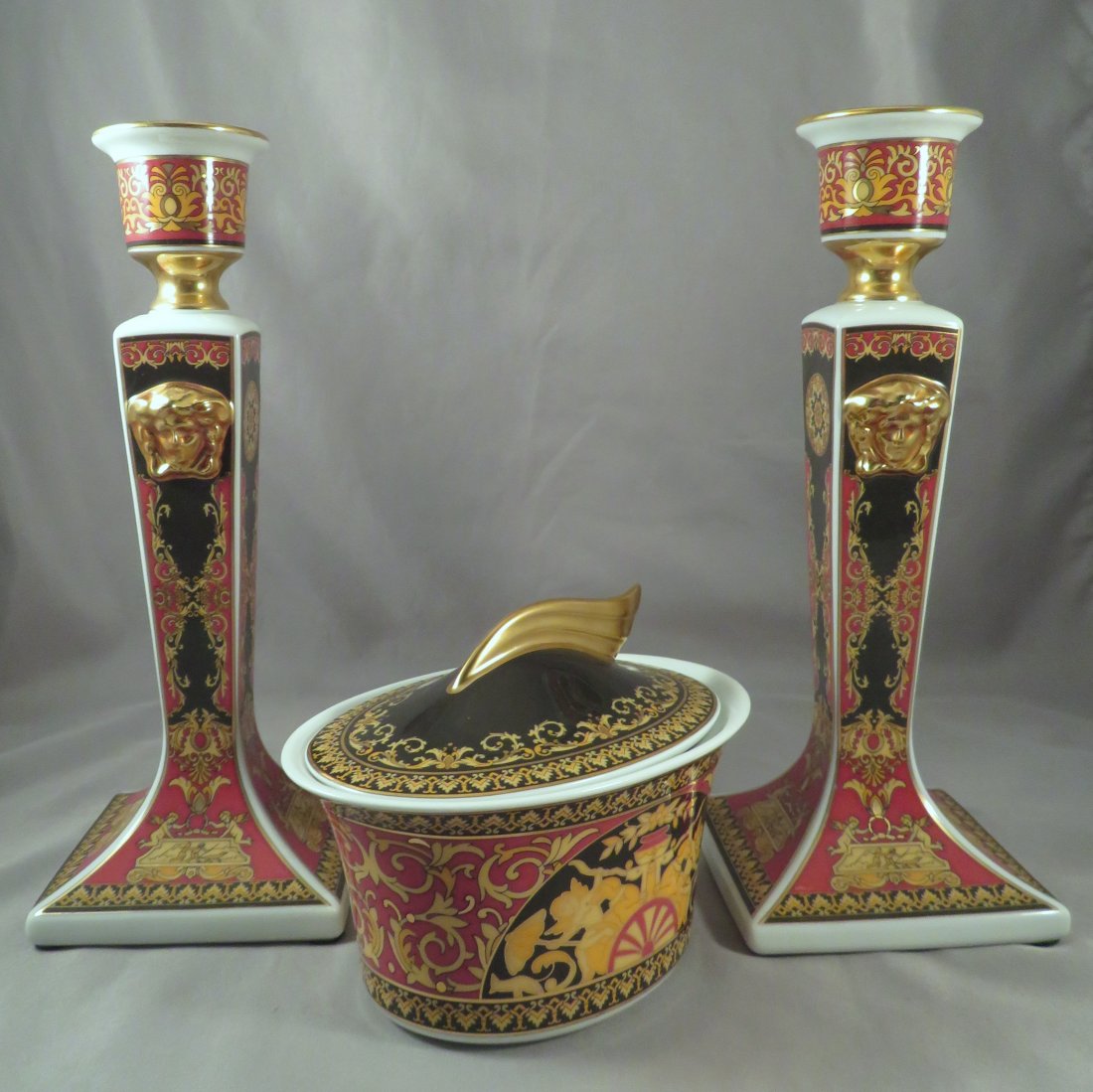 (3) Versace MEDUSA RED by Rosenthal Porcelain Pieces: Designer: Versace Manufacturer: Rosenthal Porcelain Location of Manufacture: Germany Period of Manufacture: 1994-present Dimensions of Candlesticks (each): 8 1/2" tall ; 3 1/4" square base Dimensions 