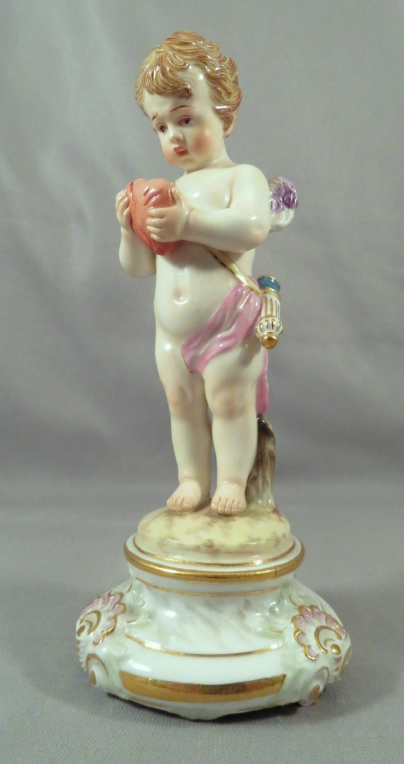 1815-1924 Meissen Porcelain M102 Cupid w/ Heart Figure: Manufacturer: Meissen Likely Designer: Heinrich Schwabe Location of Manufacture: Germany Design Period: c.1881 Title: Cupid Mending Broken Heart Dimensions: 5 1/2"(h) Weight: 5 ounces For your conside