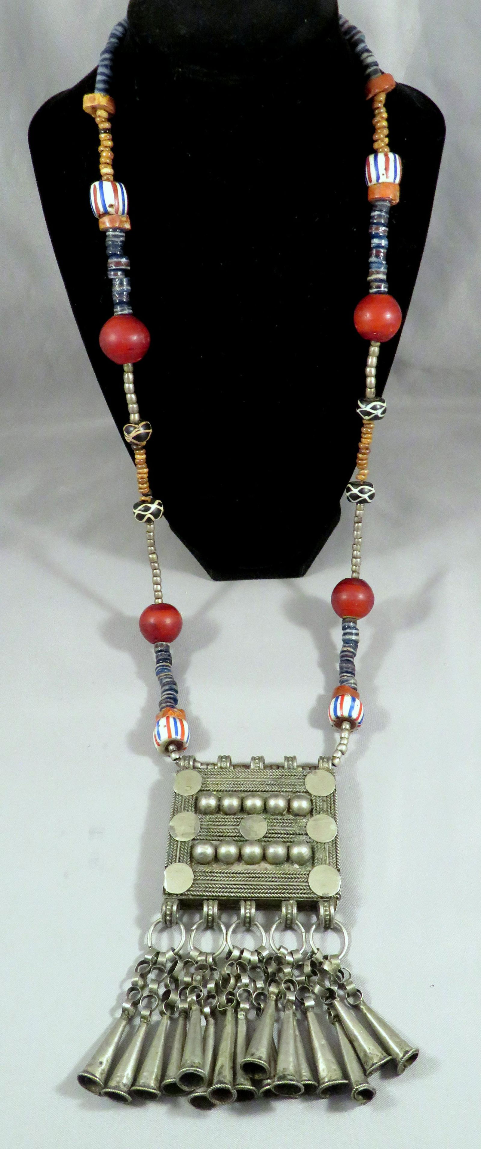 Antique Afghan Central Asian Silver & Bead Necklace: Location: Central Asia (Afghanistan/Turkmenistan) Materials: Silver & Glass Trade Beads Length of Necklace: 28" Pendant Dimensions: 2 1/2"(w) x 5"(l) Drop Measurement: 18 1/2" Weight: 7 ounces For you