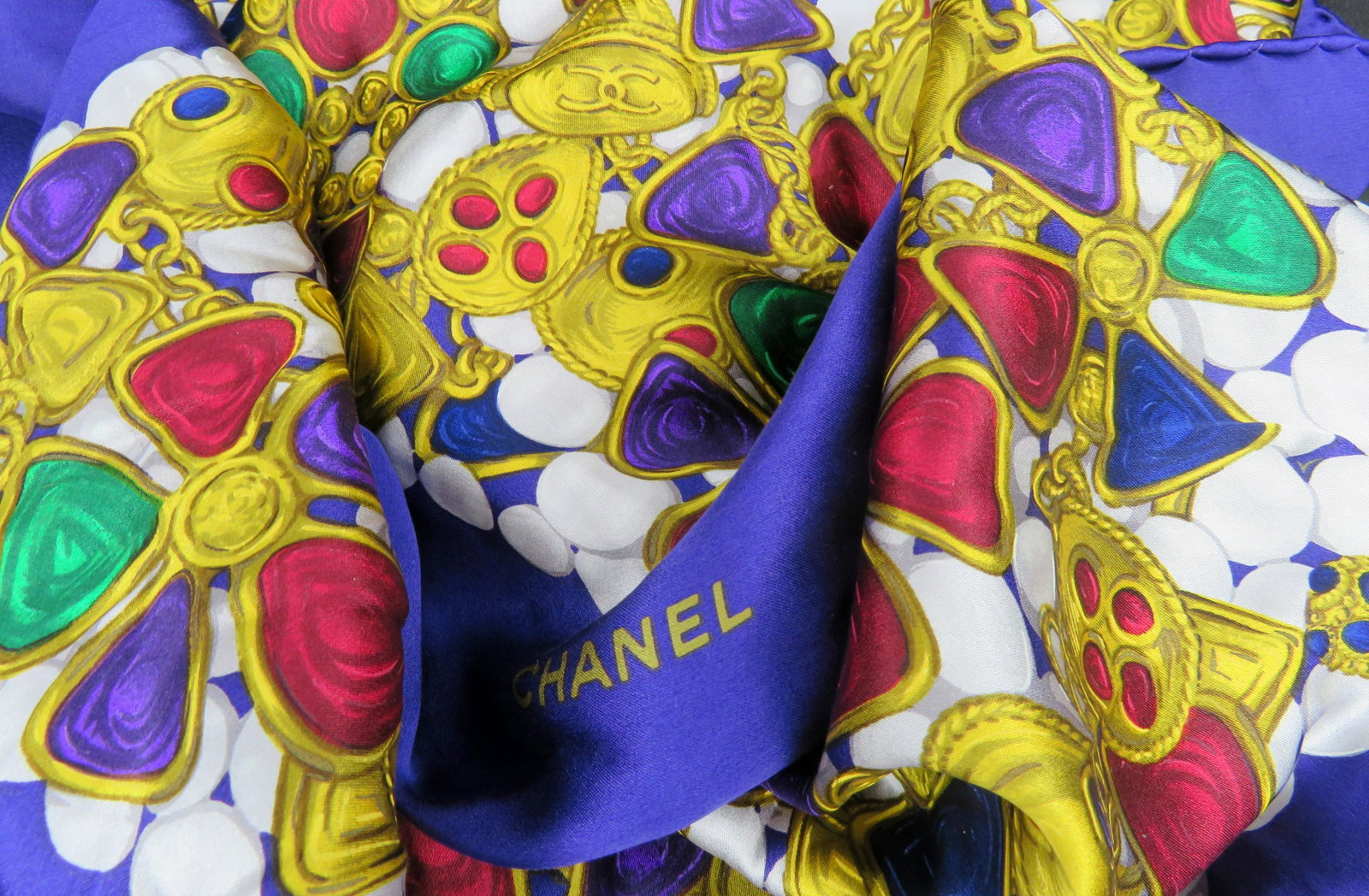 Authentic Chanel Jewel Toned Gripoix Pearl Silk Scarf: Maker: Chanel Dimensions: 35" square For your consideration is a stunning and rare authentic Chanel "Treasure Chest" silk scarf. This opulent scarf depicts mounds of Chanel's most recognizable jewels 