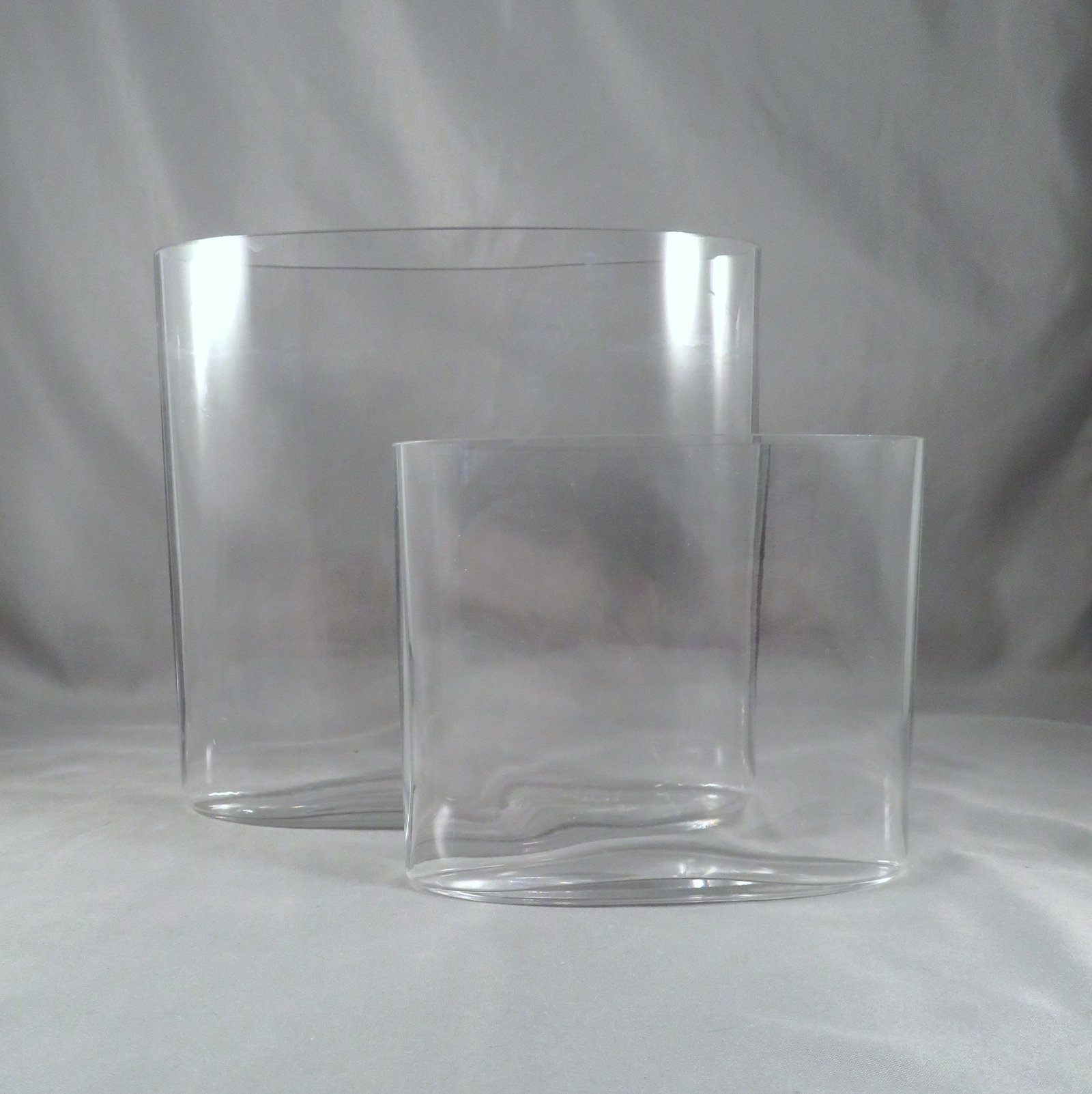 PAIR of Tapio Wiirkala Iittala Clear OVALIS Vases c1958: Designer: Tapio Wiirkala (1915-1985) Manufacturer: Iittala Glassworks Location of Manufacture: Iittala, Finland Design Date: 1958 Design Line: Ovalis Dimensions of Large Vase: 6"(h) x 6 1/2"(w) x 2 1/