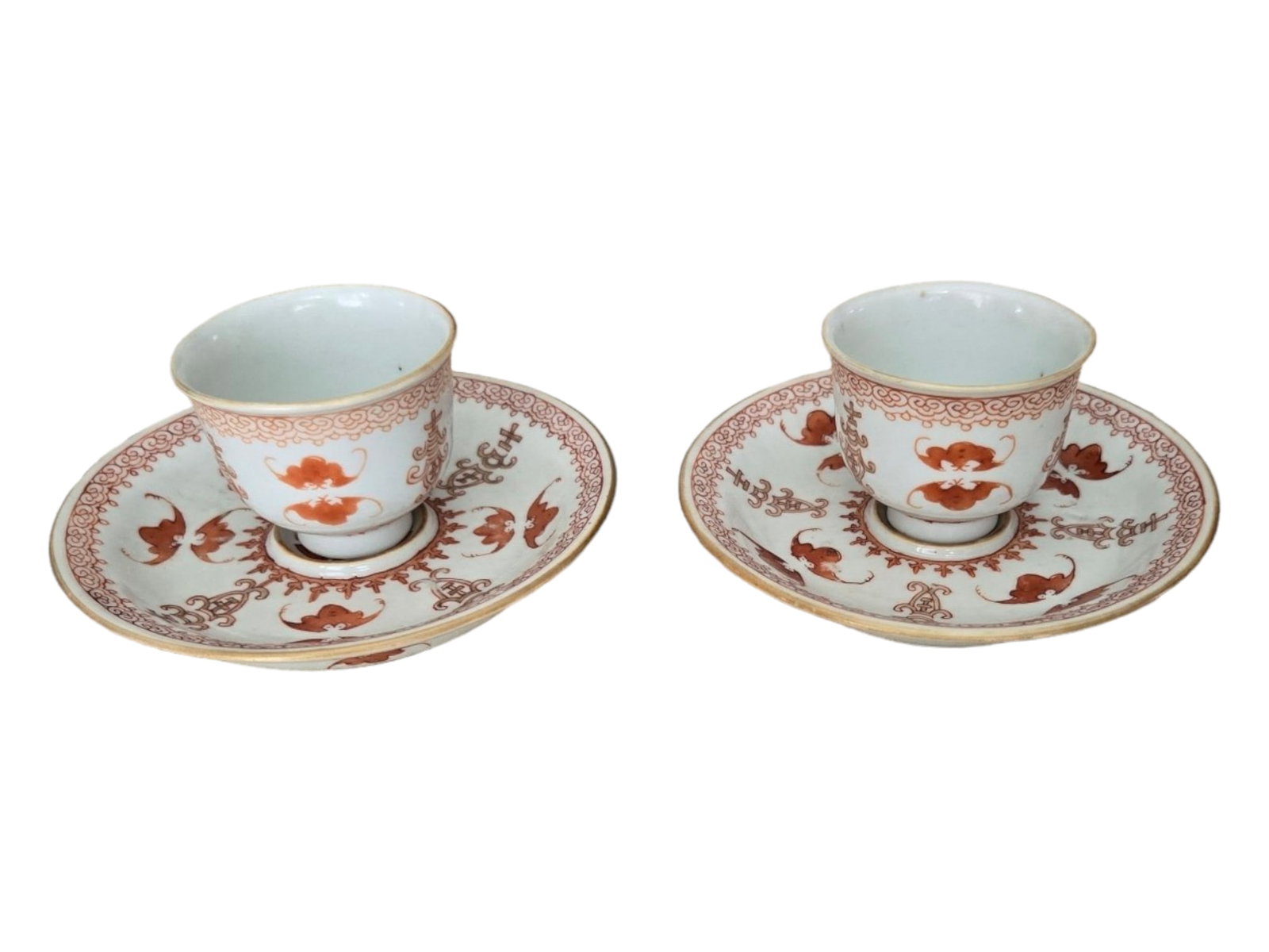 Marked Pair of Chinese Porcelain Wine Cups & Saucers with Iron Red Bat Decoration: Two (2) Chinese Wine or Spirits Cups and Saucers with Iron Red Bat Decoration, Marked Qianlong Dynasty Location of Manufacture: China Marked: Qing Dynasty (1644-1912) Dimensions of Each Cup: 1 5/8"(h)
