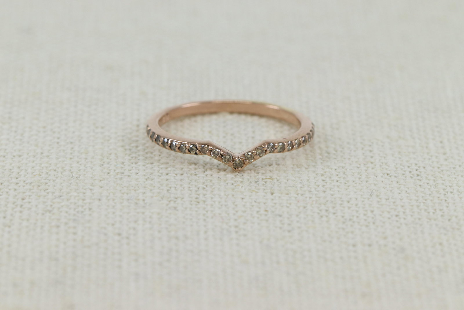 14KT Modern Stackable Diamond Ring: A ladies 14kt Rose Gold Modern Stackable diamond band. Thering has a total of 23 round brilliant Champaigne diamonds. The diamonds weight approx: 0.48cttw. Ring size: 7.00.