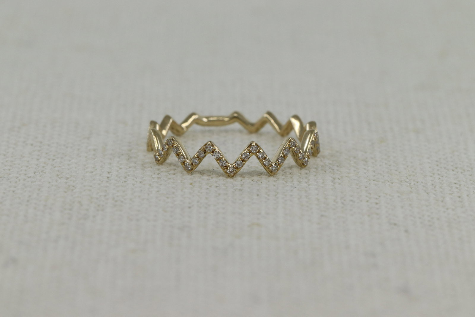 14Kt Modern Diamond Ring: A ladies 14kt Yellow Gold Modern Stackable diamond ring. The ring has a total of 31 round diamonds. Ring size: 5.75.