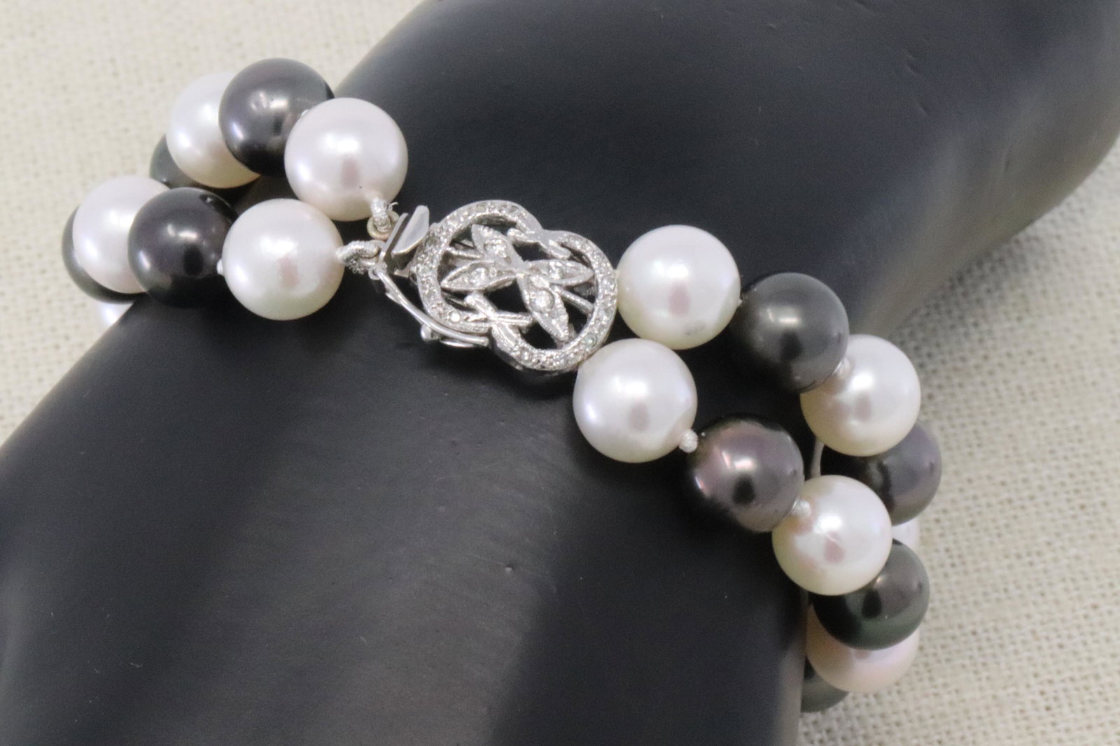 14Kt Akoya 2 Strand Pearls Bracelet: A ladies White and Black Akoya Pearls. The Pearls measure 8.50mm. Clasp is 14kt White Gold with diamonds. Length of 2 strand Pearl bracelet: 7.00"