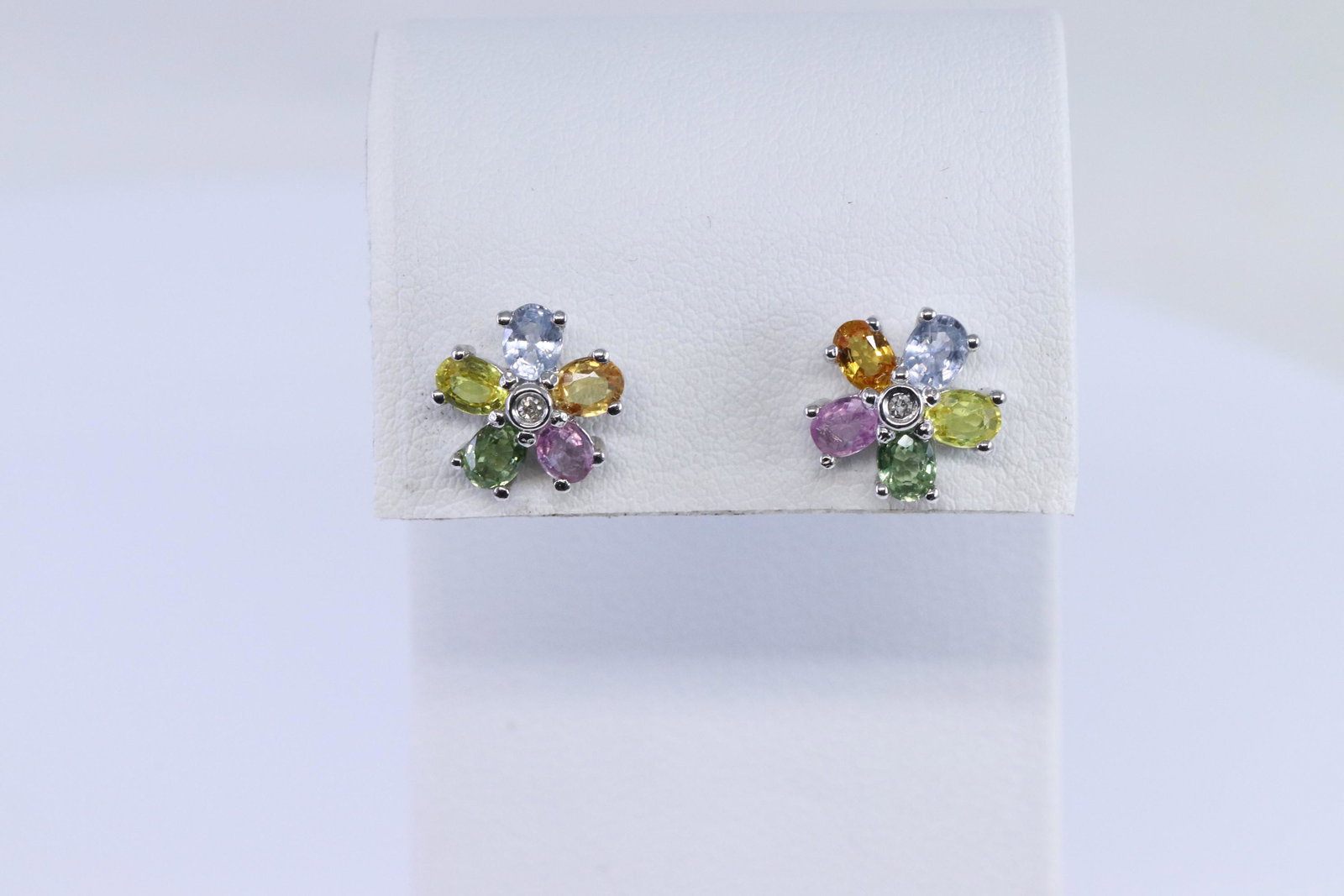 14Kt Multi-Color Diamond Earrings: A ladies 14kt White Gold Diamond earrings. Earrings has a total of 2 round brilliant diamonds. Gemstones color: Amethyst, Peridote, Citrine, Tanzanite, Tourmaline stones. Total weight: 2.13 grams.