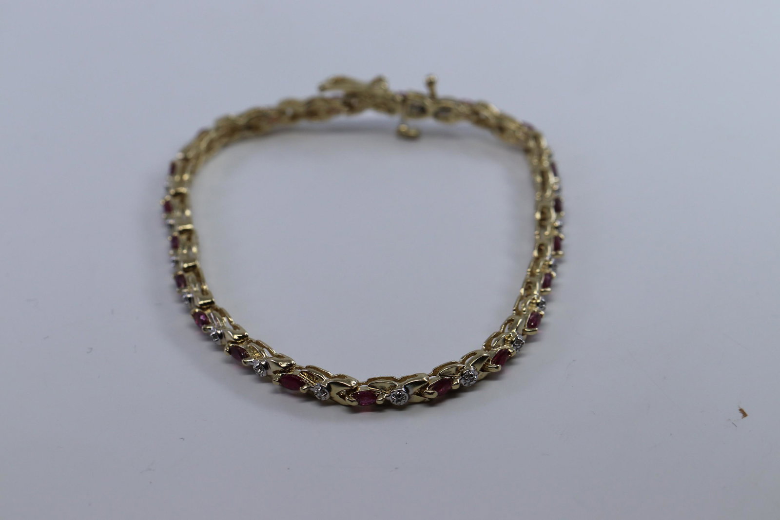 14Kt Ladies Diamond | Ruby Bracelet.: A ladies 14kt Yellow Gold Diamond bracelet with Marquise Shape Ruby's. The bracelet has a total of 21 round brilliant diamonds & 21 ruby's. Bracelet length: 7.00 in. Total bracelet weight is 8.30g.