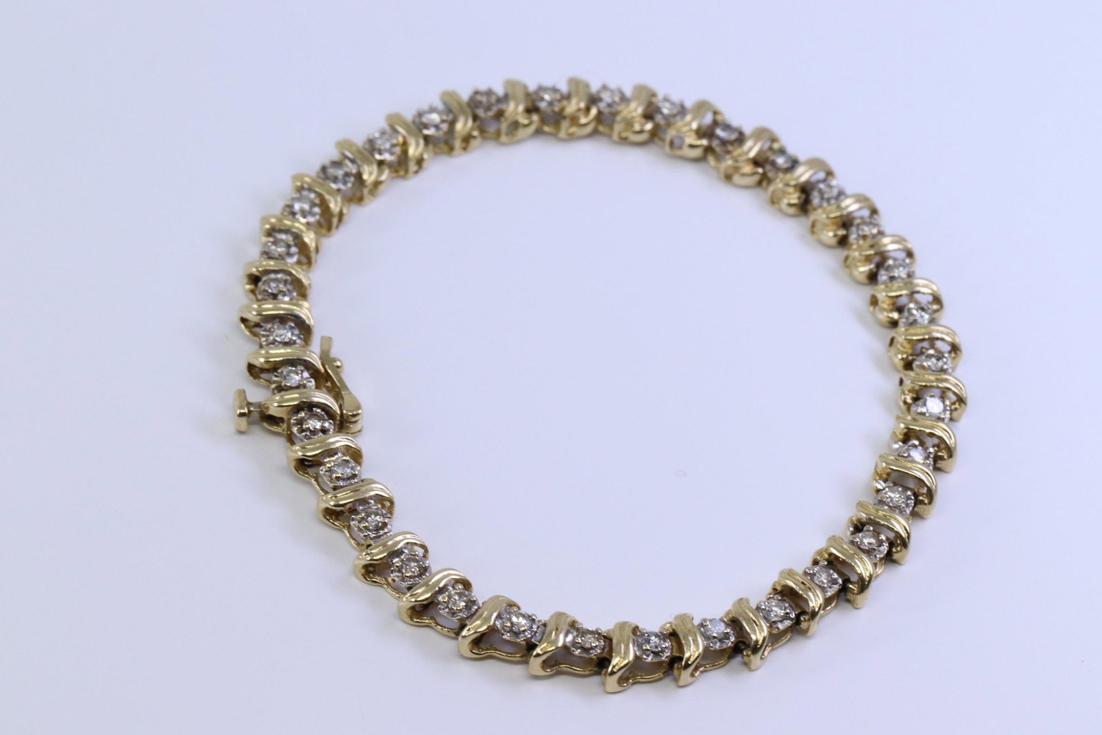 14Kt Ladies Diamond Bracelet: A ladies 14kt Yellow Gold Diamond bracelet. Bracelet has a total of 35 round brilliant diamonds. Diamonds weight approx 2.50cttw. Length: 7.50in. Total weight: 11.37 grams.