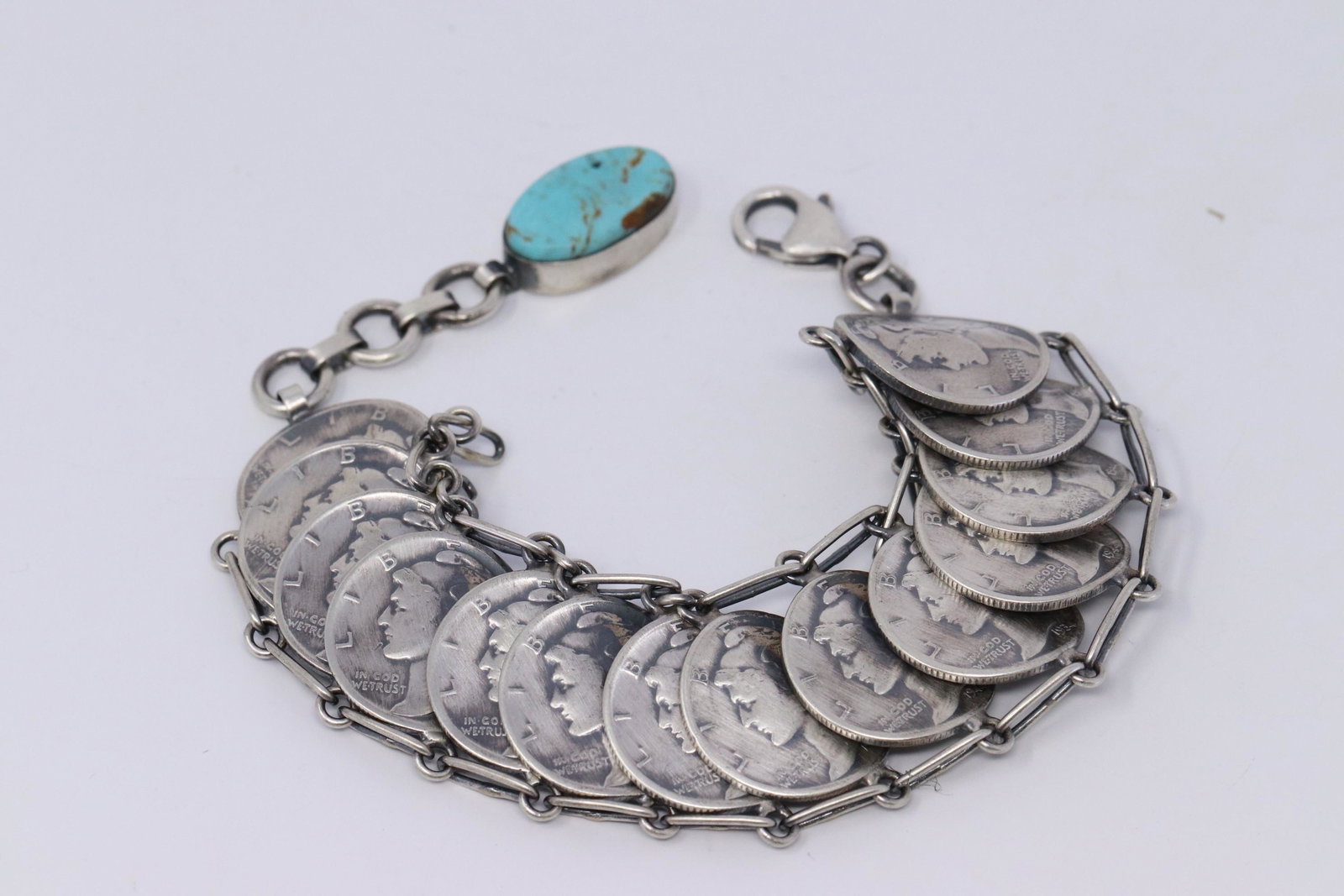 Native American Navajo Handmade by James McCabe Silver: This is a Native American Navajo Handmade by James McCabe Silver Liberty Dime Bracelet with Turquoise. Bracelet length is 7.50.