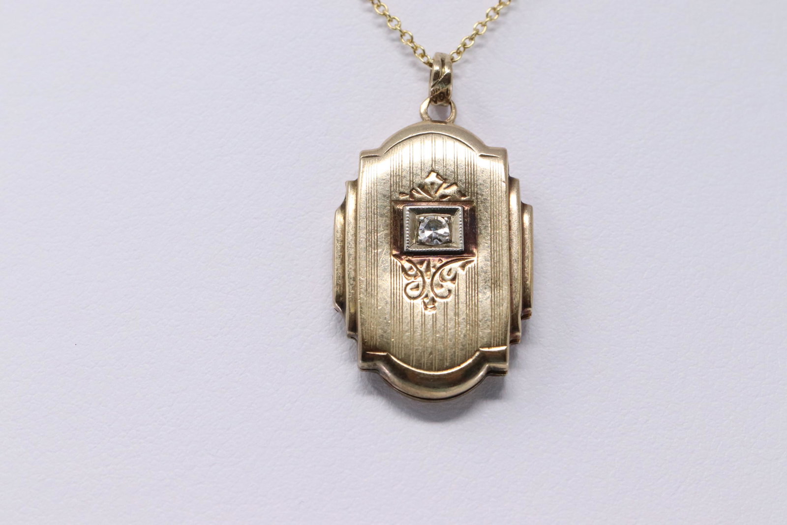 Vintage 14K Gold Locket with diamond: Vintage 14k gold locket with 0.05 appx ct center stone, Chain 14k yellow gold measures 16". Total weight 3.8 grams
