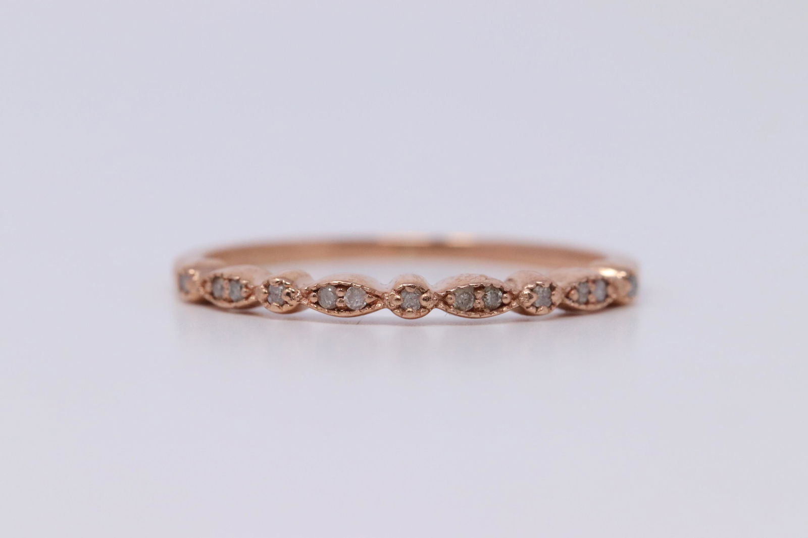 14KT Rose Gold Diamond Stackable Ring: A ladies 14kt Rose Gold Diamond ring. Ring is a stackable/band with a total of 13 round diamonds. Ring size: 6.50. SKU: AJF0FNV
