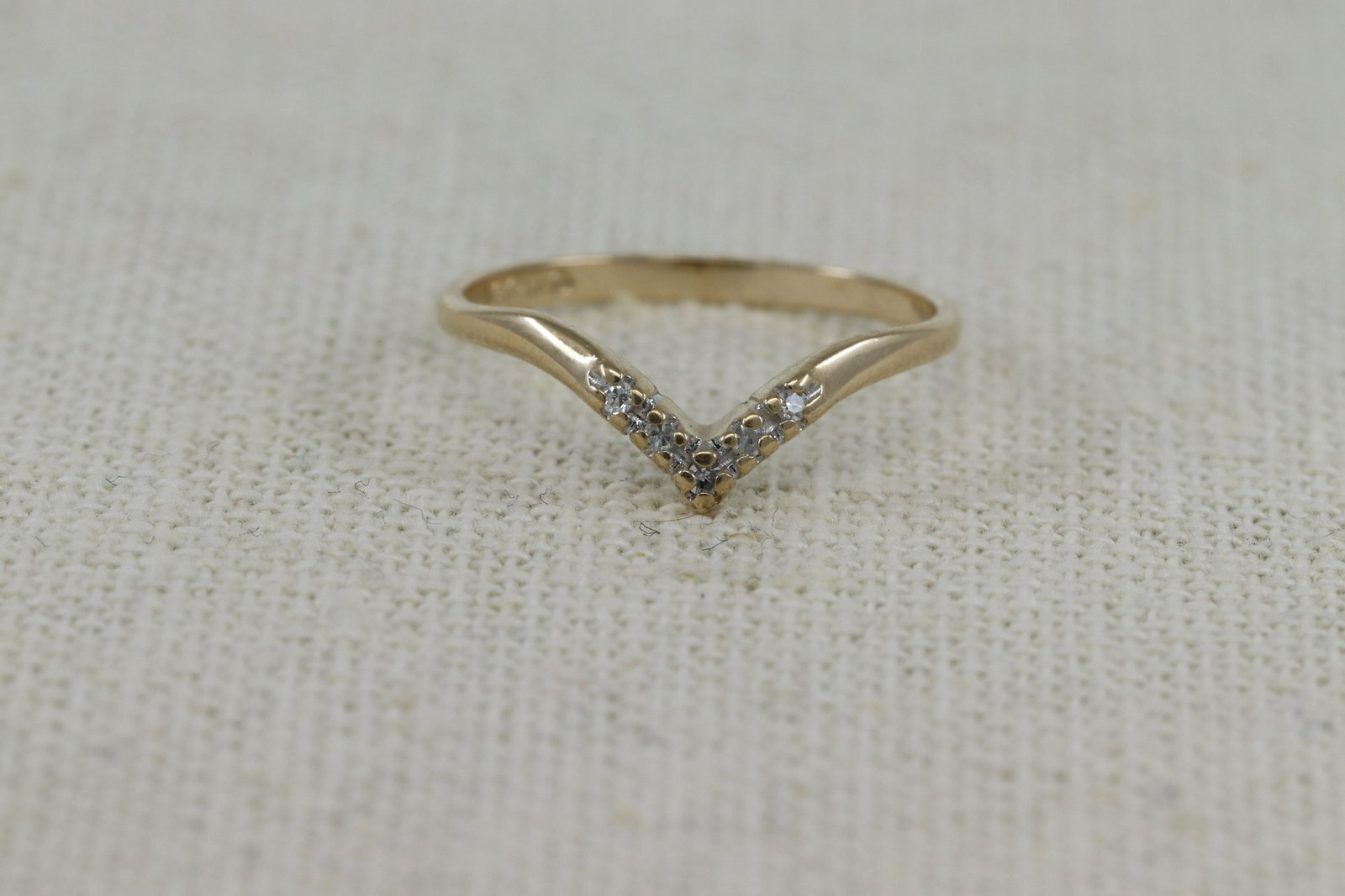 14Kt Stackable Diamond Ring: A ladies 14kt Modern stackable diamond ring. The ring has a total of 5 round diamonds. The ring size: 7.00.