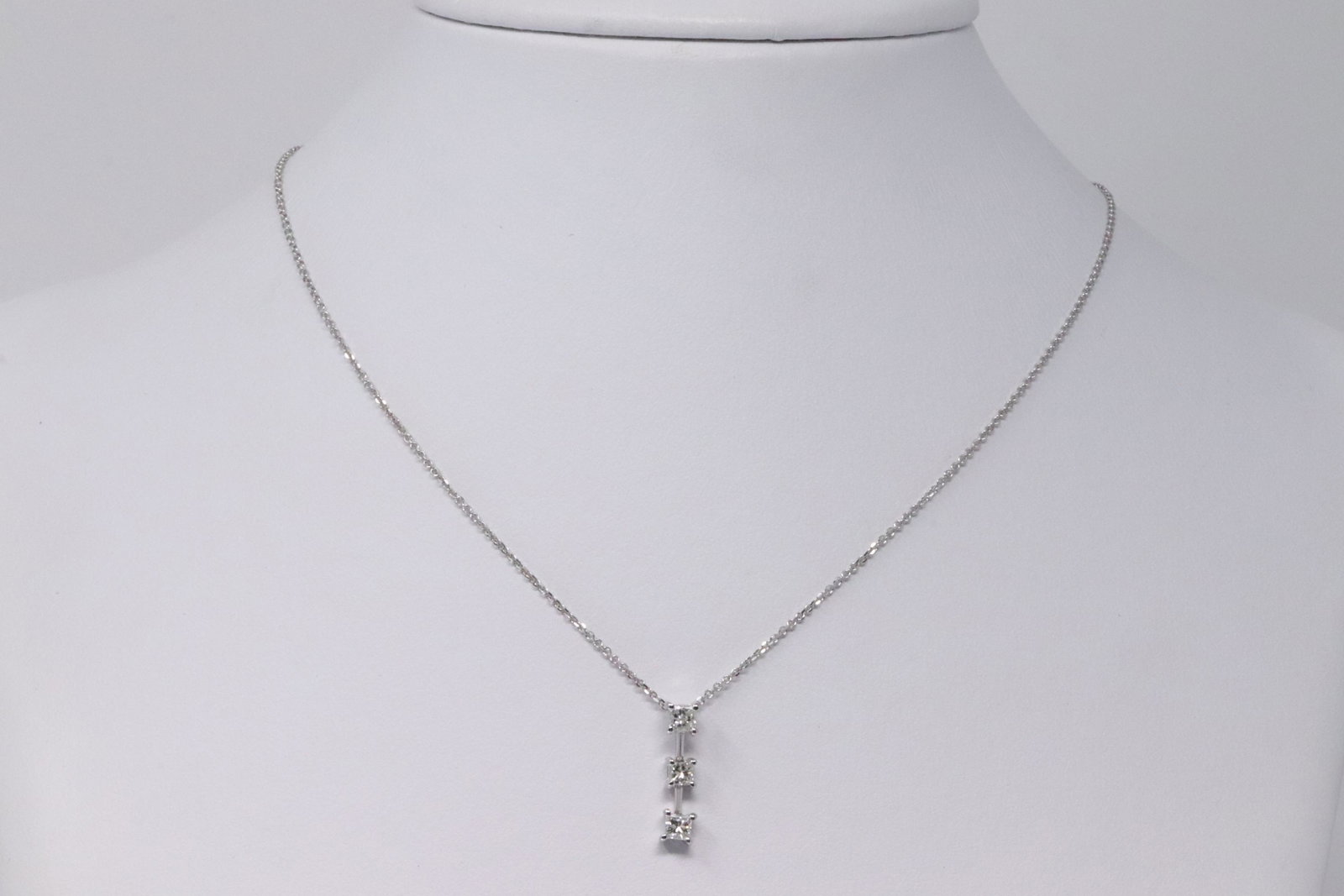 18K White Gold with 3 Diamond Pendant necklace: This is a 18k white gold 3 diamonds, princess cuts Appx 0.49 CTW. Necklace measures 16". Total weight 2.6 grams
