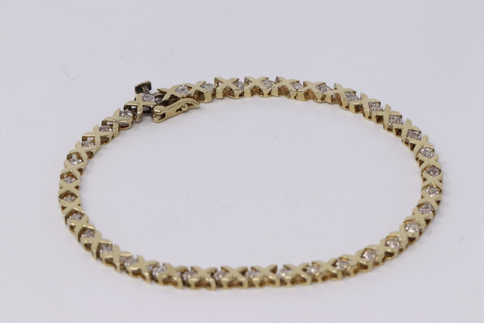 14Kt Diamond Ladies Bracelet: A ladies 14kt Yellow Gold Diamond bracelet. Bracelet has a total of 35 round diamonds. Length: 7.50in . Total weight: 6.90 grams.