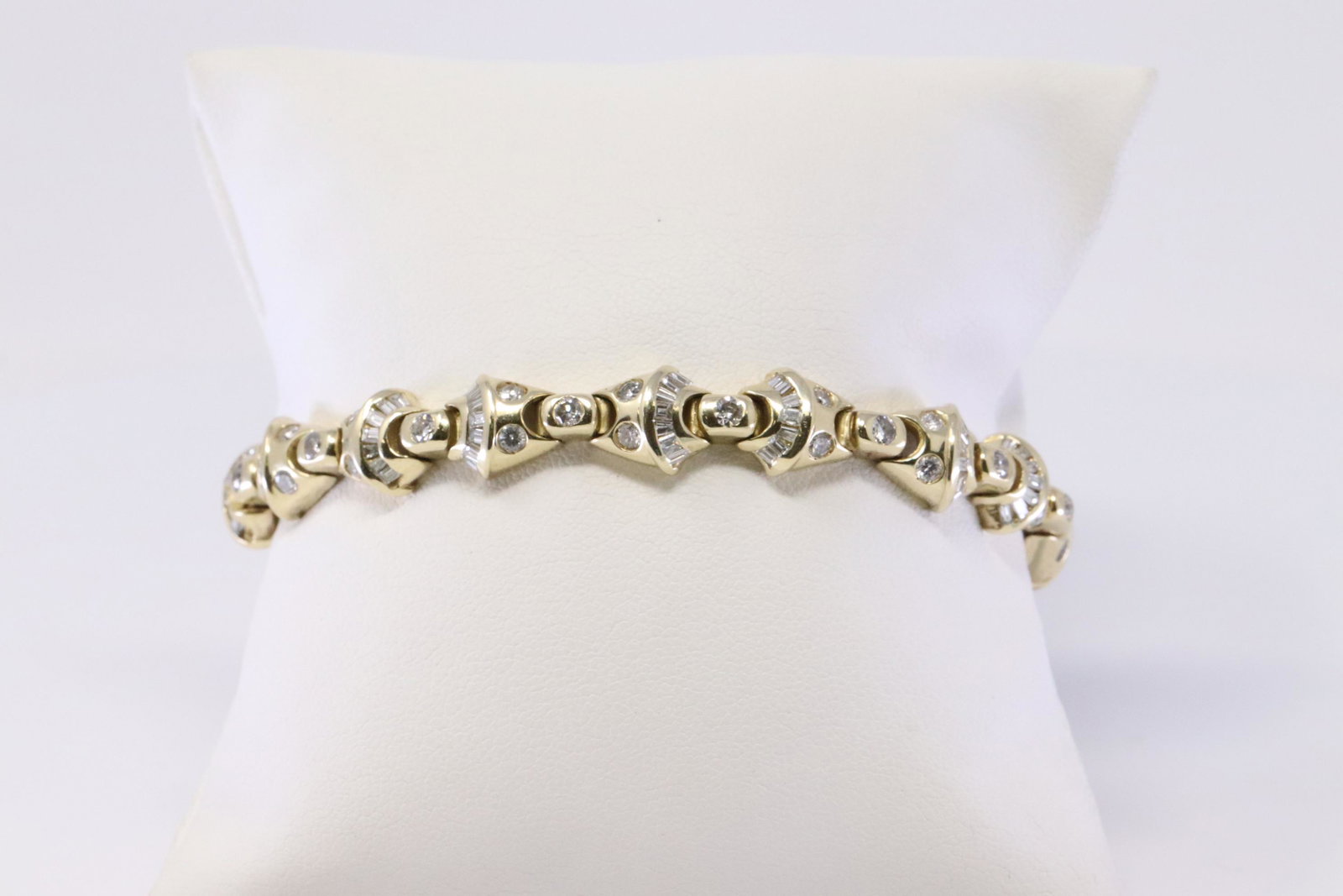 14K Diamond Tennis Bracelet: This is a 14k yellow gold diamond tennis bracelet, Baguette appx 1.05ctw, and round diamonds appx 1.35ctw, 2.40 TCW. Bracelet measures 7 inchs. Total weight of bracelet 25.4 grams. RA9512