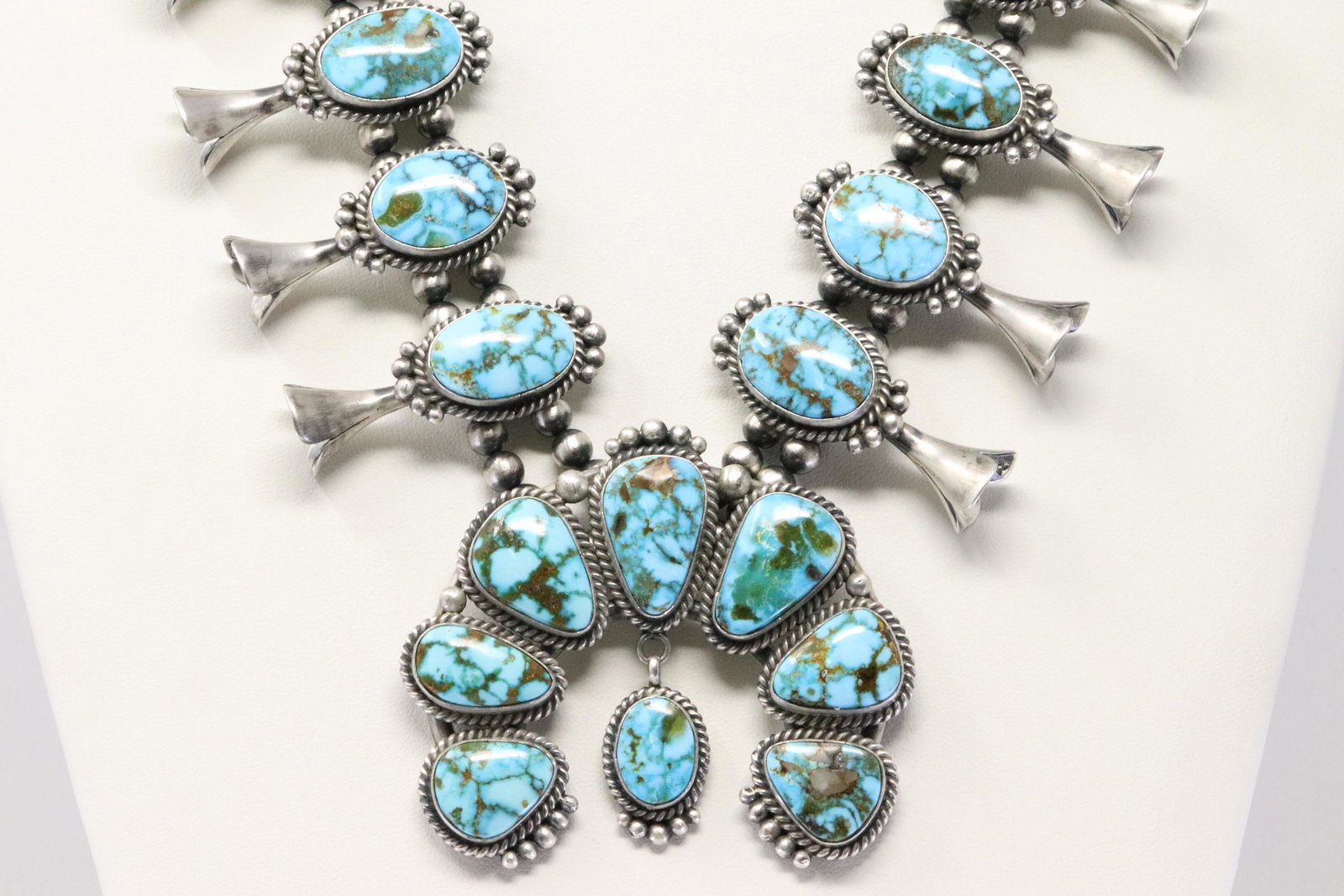 Native American Navajo Handmade Sterling Silver Naja: This is a Native American Navajo Handmade Sterling Silver Naja Kingman Turquoise Squash Blossom Necklace & earring's Set By Mary Ann Spencer. 26.00"