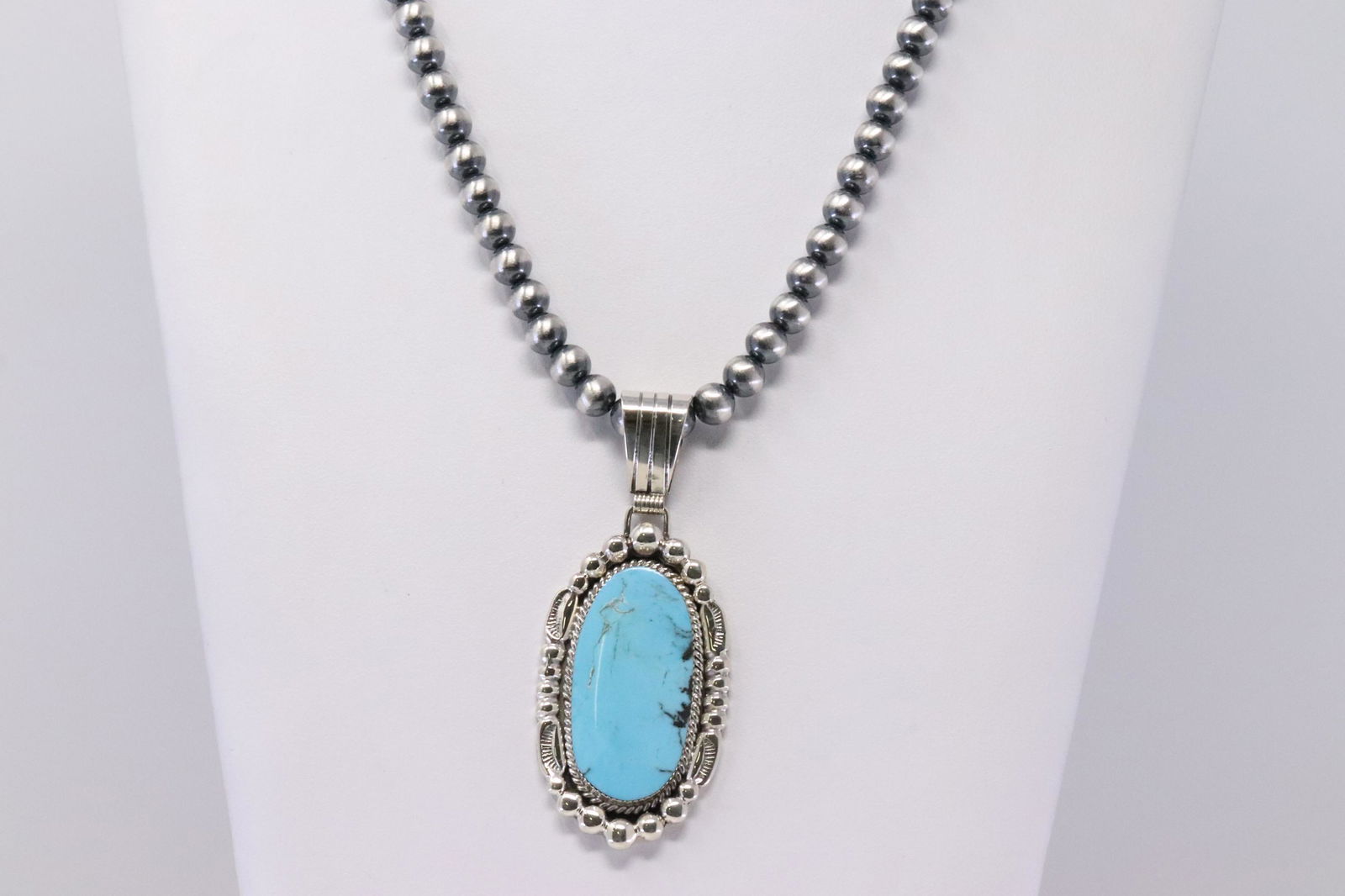 Native America Navajo Sterling Silver Turquoise Pendant: This is a Native America Navajo Sterling Silver Turquoise Pendant & Pearl Beaded Necklace By Mike Smith. Necklace length: 22.00"