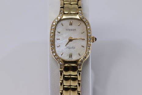 Tissot Ladies 14KT Diamond Watch: A ladies 14kt Yellow Gold Tissot ladies watch. Watch has a total of 34 round diamonds set on the bezel. Dial: Mother Of Pearls. Crown: Blue Sapphire. Made: Swiss Made. Length: 7.00". Total weight: