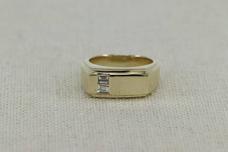 14Kt Men's Diamond Ring: A Men's 14kt yellow gold diamond ring. The ring has a total of 2 squared baguette cut diamonds. The diamonds weigh approx 0.25cttw. Ring size: 7.25. 14KT Ring total weight: 9.00 grams.