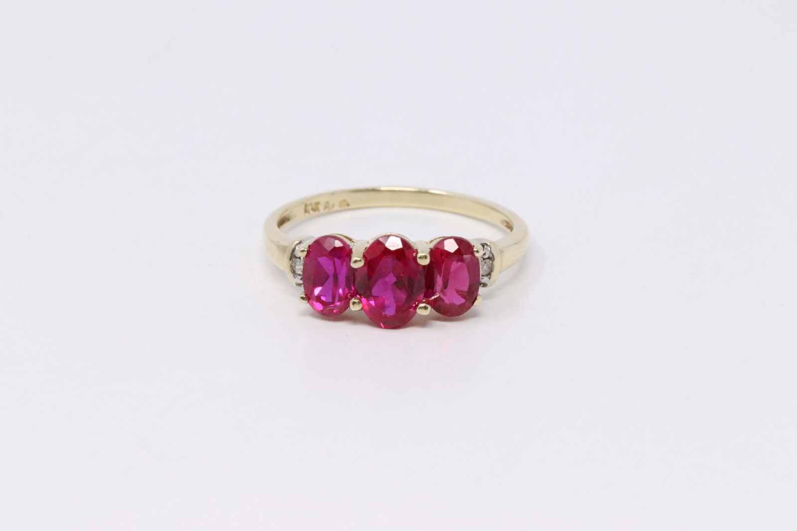 Ladies 10k yellow gold Stimulant Ruby & Diamond Accent: This is a 10k ladies yellow gold Ruby Stimulant and diamond accent ring, ring size 6 3/4. Total weight 2.10 grams. SP-8G2V1