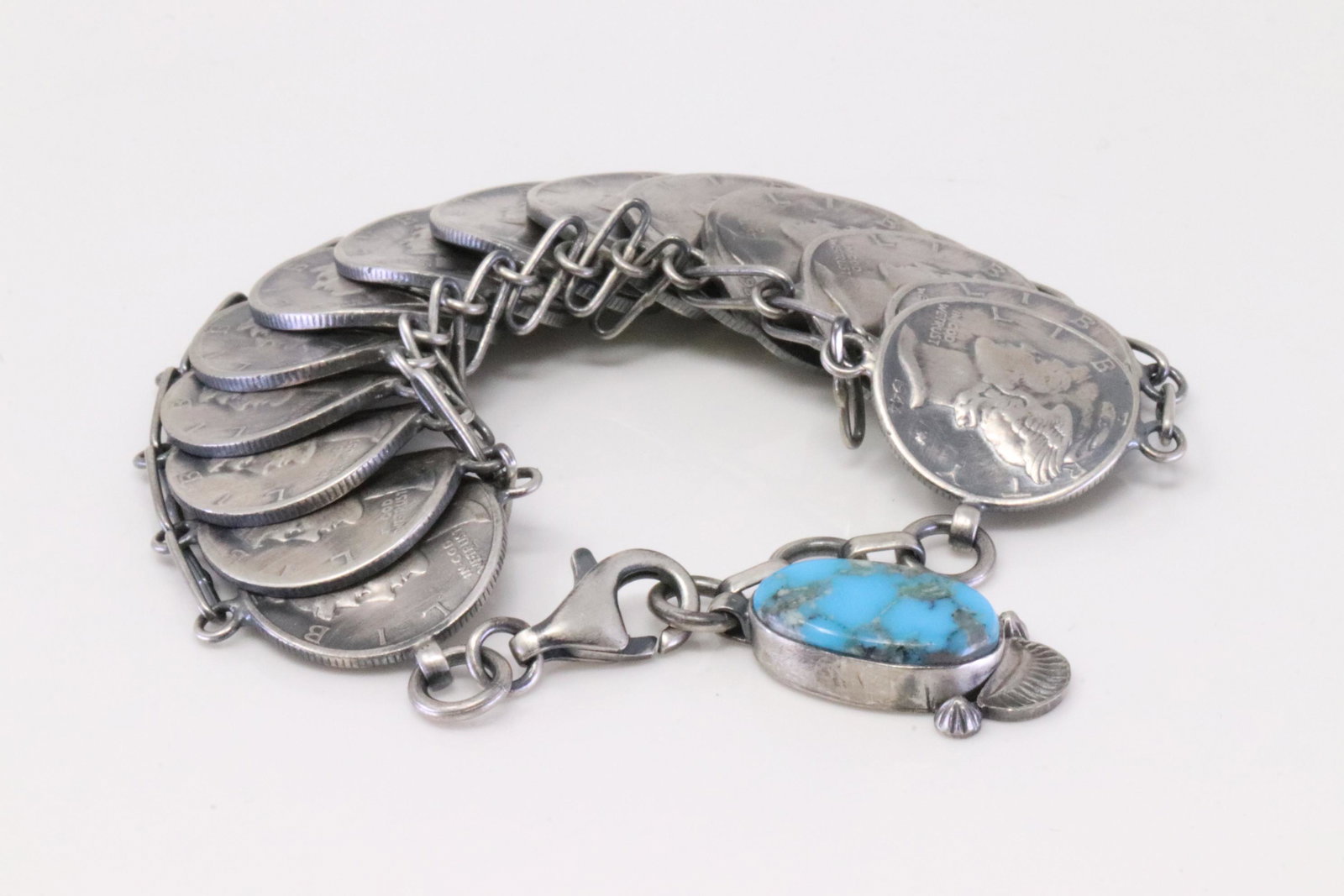 Native American Navajo Handmade Sterling Silver Turquoise Liberty Dime Bracelet By James McCabe.: This is a Native American Navajo Handmade Sterling Silver Turquoise Liberty Dime Bracelet By James McCabe. Bracelet length: 7.00"