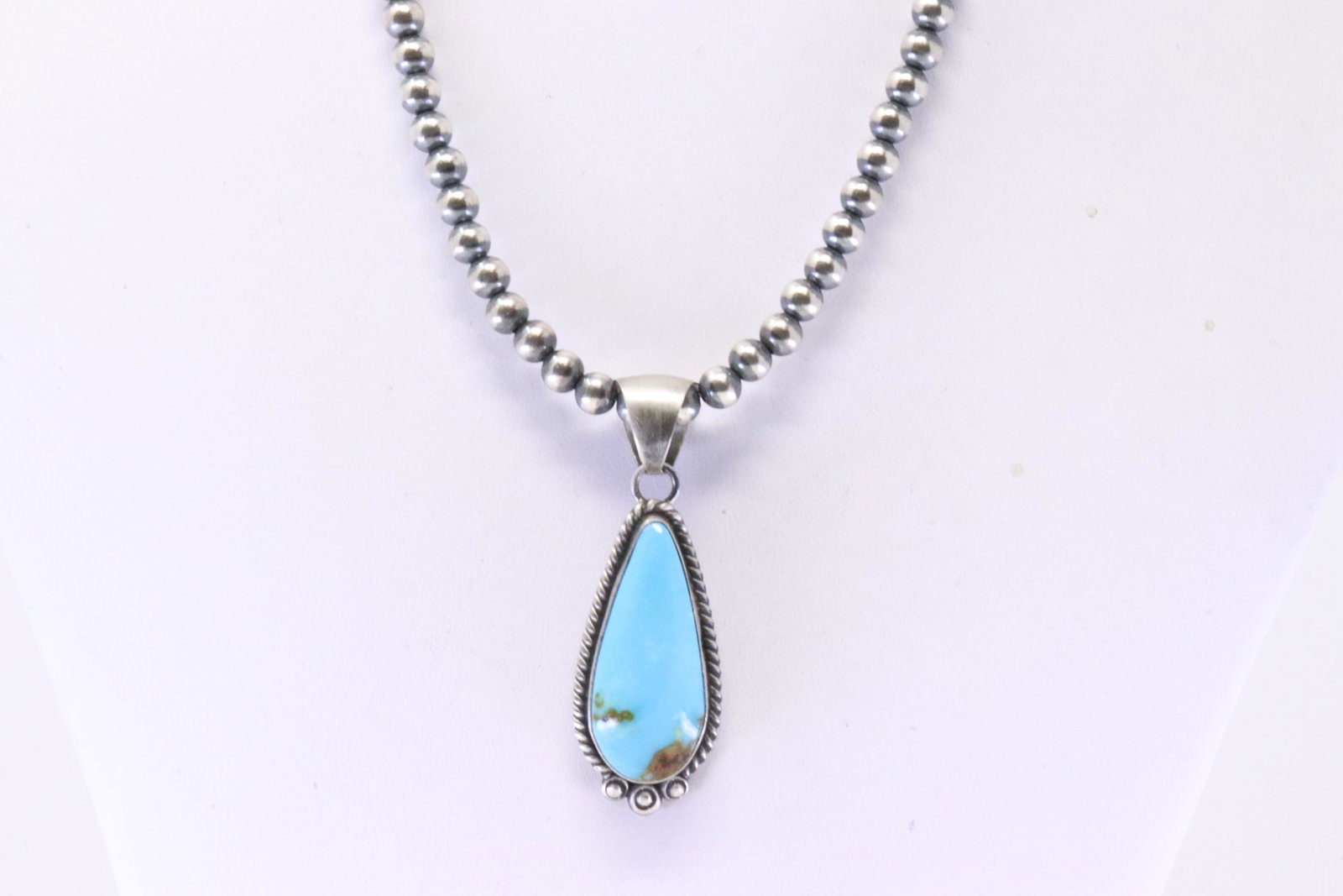 Native America Navajo Sterling Silver Kingman Turquoise Pendant By Alfred Martrinez. With Pearl: This is a Native America Navajo Sterling Silver Kingman Turquoise Pendant By Alfred Martrinez. With Pearl Beaded Sterling Silver Machine Made Necklace. Necklace length: 16.00"