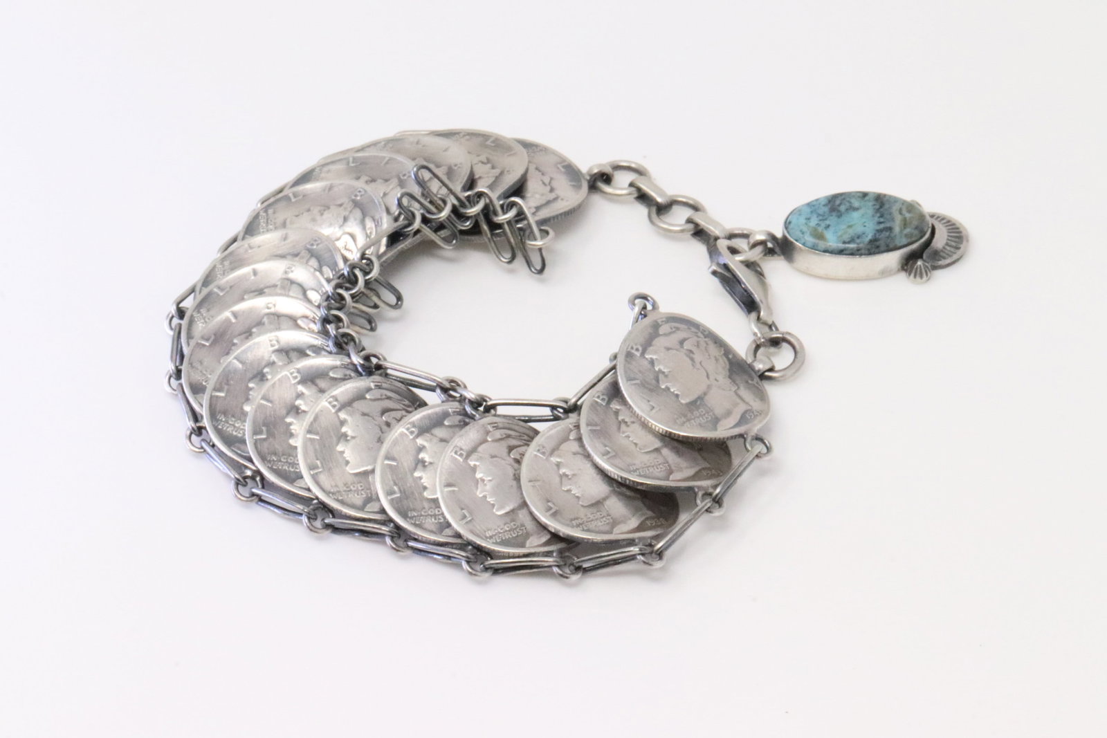 Native America Navajo Sterling Silver Turquoise Liberty Dime Bracelet Link By James McCabe.: This is a Native America Navajo Sterling Silver Turquoise Liberty Dime Bracelet Link By James McCabe. Bracelet length: 7.00" Adjustable"