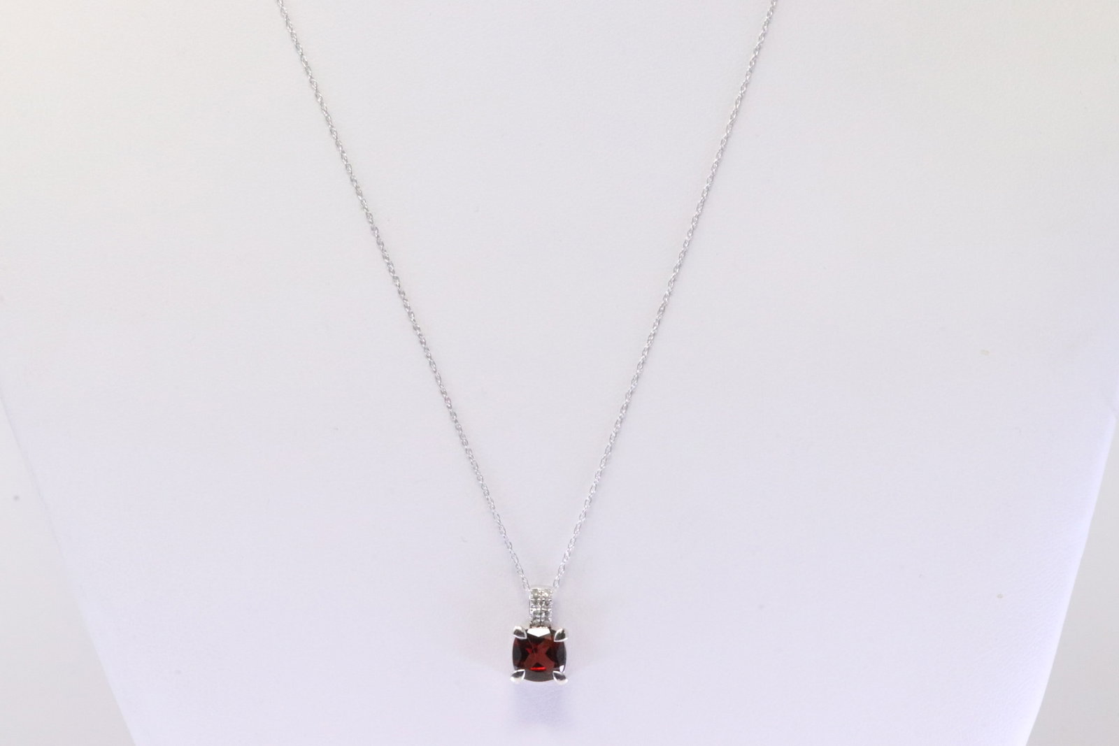 Ganert & Diamond Pendant / Necklace 10Kt.: Ladies 10Kt White Gold Garnet & Diamond Pendant / Necklace. Necklace has Pendant with Garnet Gemstone & round Diamonds. Diamonds weight: 0.05ctw. Necklace length: 18.00"