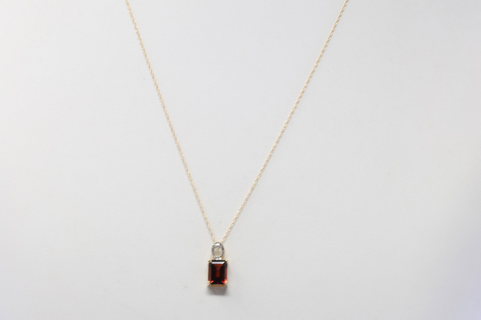 Garnet 7&Diamond Pendant / Necklace 10Kt.: Ladies 10Kt Yellow Gold Garnet & Diamond Pendant / Necklace. Necklace has one Pendant with one Cut Garnet & round Diamonds. Diamonds weight: 0.04ctw. Necklace length: 18.00"