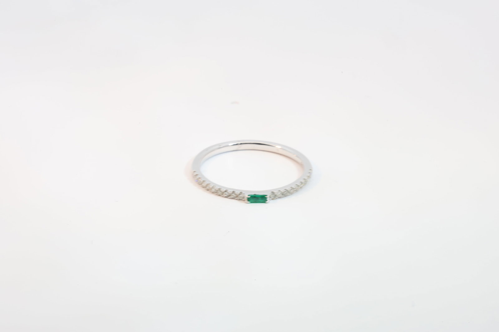 Emerald & Diamond Ring 14Kt.: Ladies 14Kt Wite Gold Emerald & Diamond Ring. Ring has one Emerald Gems & 20 round Diamonds. Diamonds weight: 0.13ct. Emerald weight: 0.05ct. Ring size: 6.50.