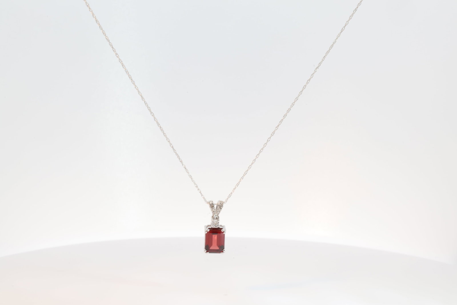 Garnet & Diamond Pendant / Necklace 10Kt.: Ladies 10Kt White Gold Garnet & Diamond Pendant / Necklace. Necklace has Pendant with Cut Garnet Gems With round Diamonds. Necklace length: 18.00"