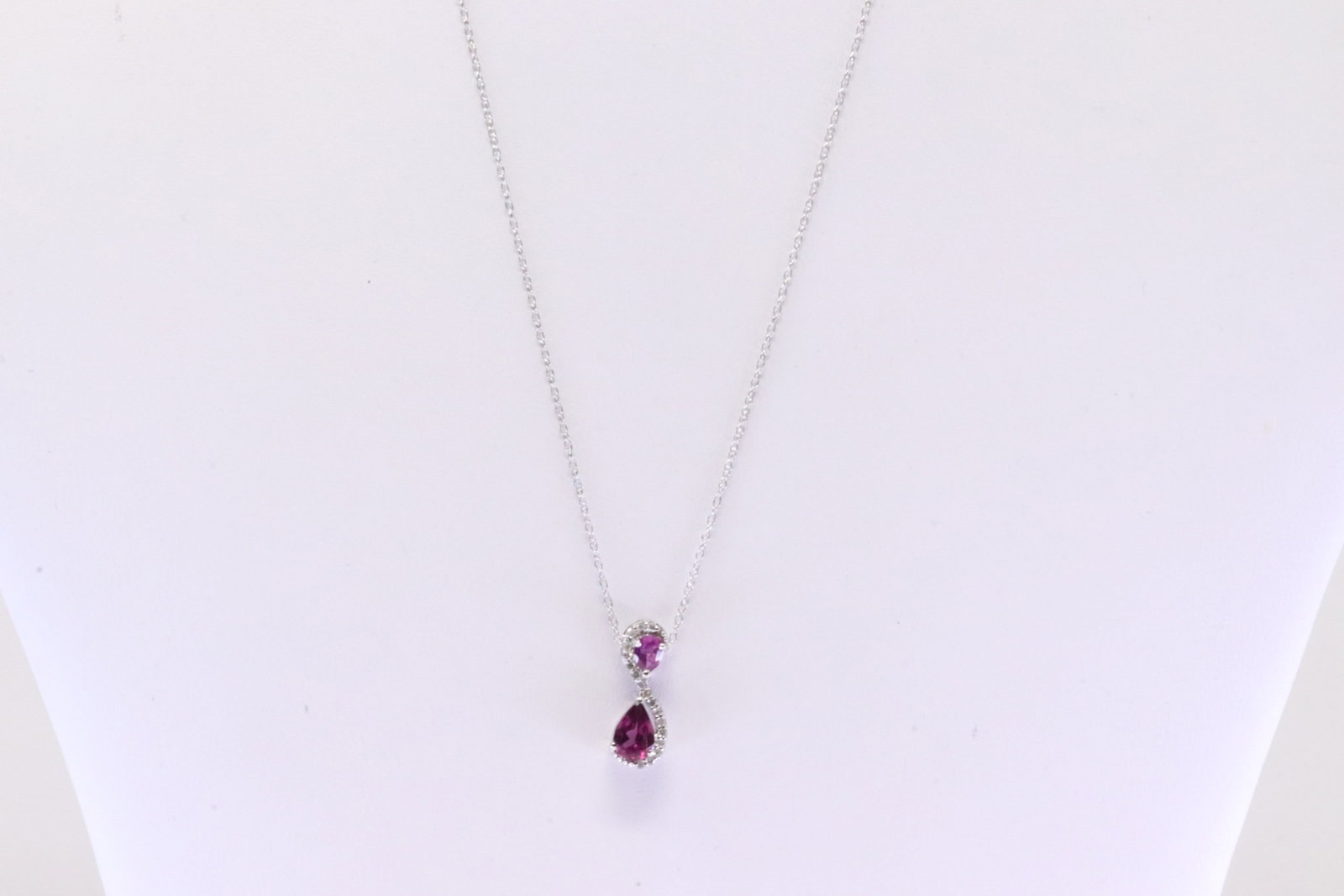 Garnet & Diamond Pendant / Necklace 10Kt.: Ladies 10Kt White Gold Garnet & Diamond Pendant / Necklace. Necklace has Pendant with Garnet Gemstone & 17 round Diamonds. Diamonds weight: 0.08ctw. Necklace length: 18.00"