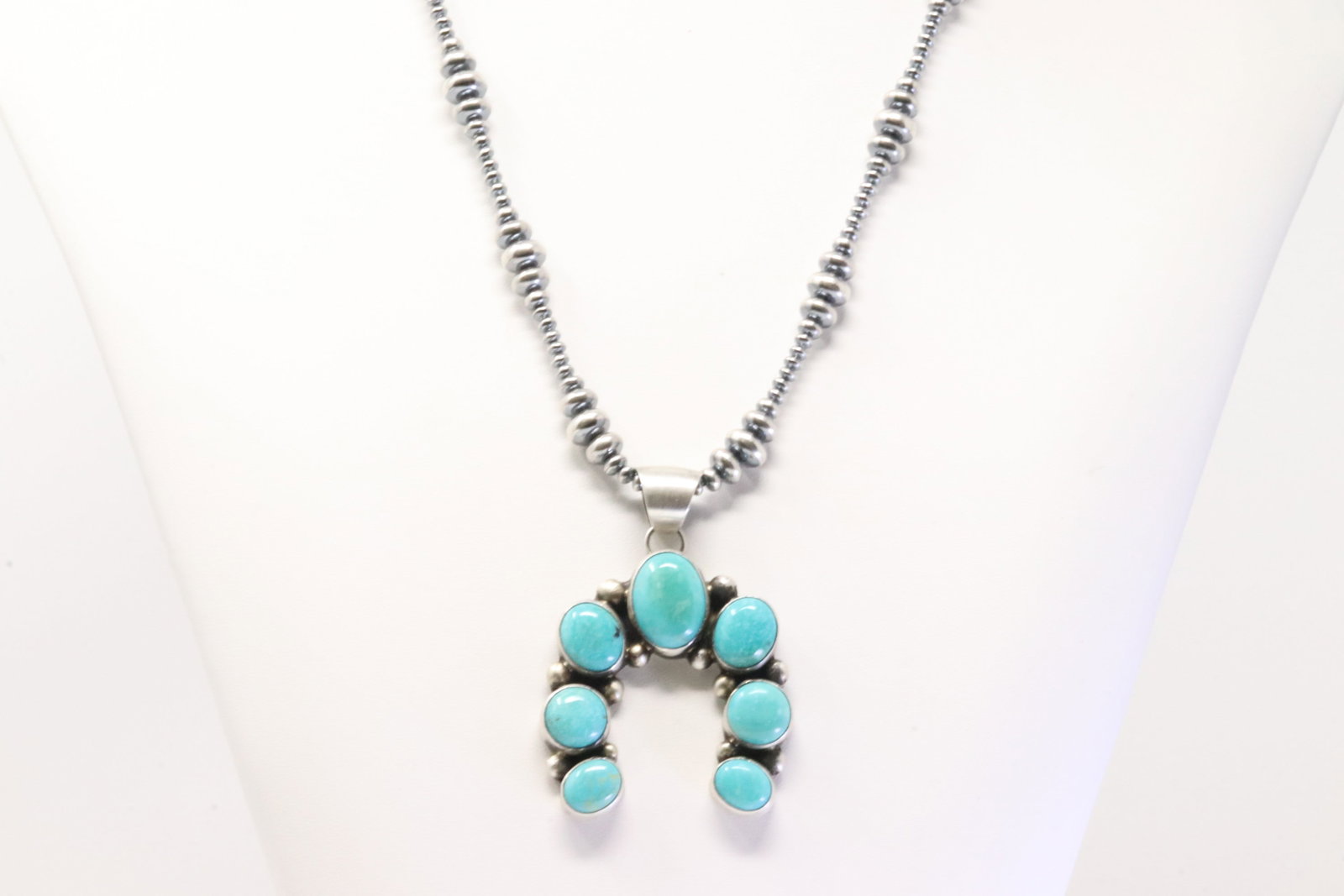 Native America Navajo Sterling Silver Kingman Turquoise Naja Pendant By Augustine Largo. With Pearl: This is a Native America Navajo Sterling Silver Kingman Turquoise Naja Pendant By Augustine Largo. With Pearl Beaded Sterling Silver Machine Made Necklace. Necklace Length: 20.00"