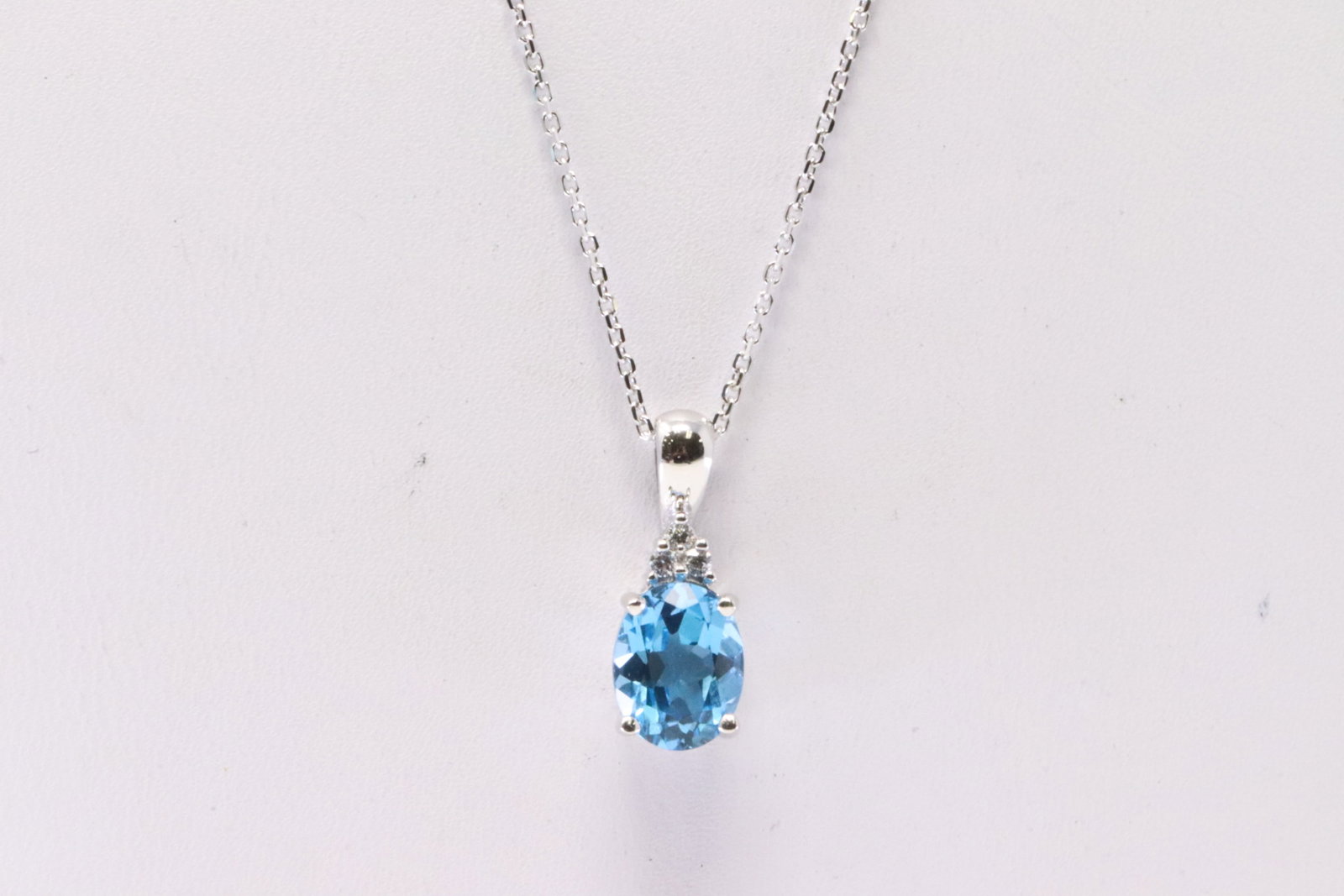 Blue Topaz & Diamond Pendant: Ladies 10Kt White Gold Blue Topaz & Diamond Pendant. Pendant has one Blue Topaz Gemstone with round Diamonds & a 14K Necklace. Necklace length: 18.00" Total weight: 3.40 Grams.
