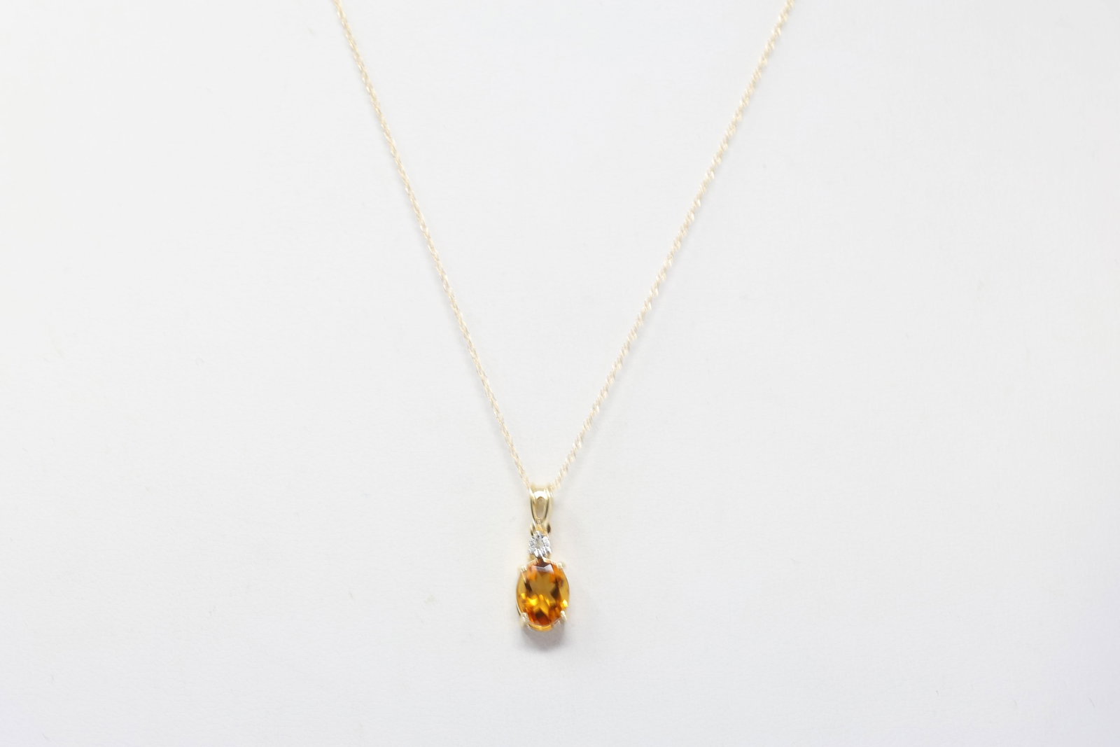 Citrine & Diamond Pendant / Necklace 10Kt.: Ladies 10Kt Yellow Gold Citrine & Diamond Pendant / Necklace. Necklace has one Pendant with Oval Citrine Gemstone & 1 round Diamond. Necklace length: 18.00"