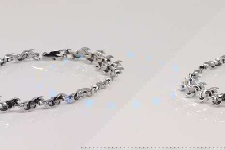 Blue Topaz Tennis Bracelet 14Kt.: 14Kt White Gold Blue Topaz Tennis Bracelet. Bracelet has 20 Blue Topaz Gemstone. Bracelet length: 8.00" Total weight: 13.90 Grams.